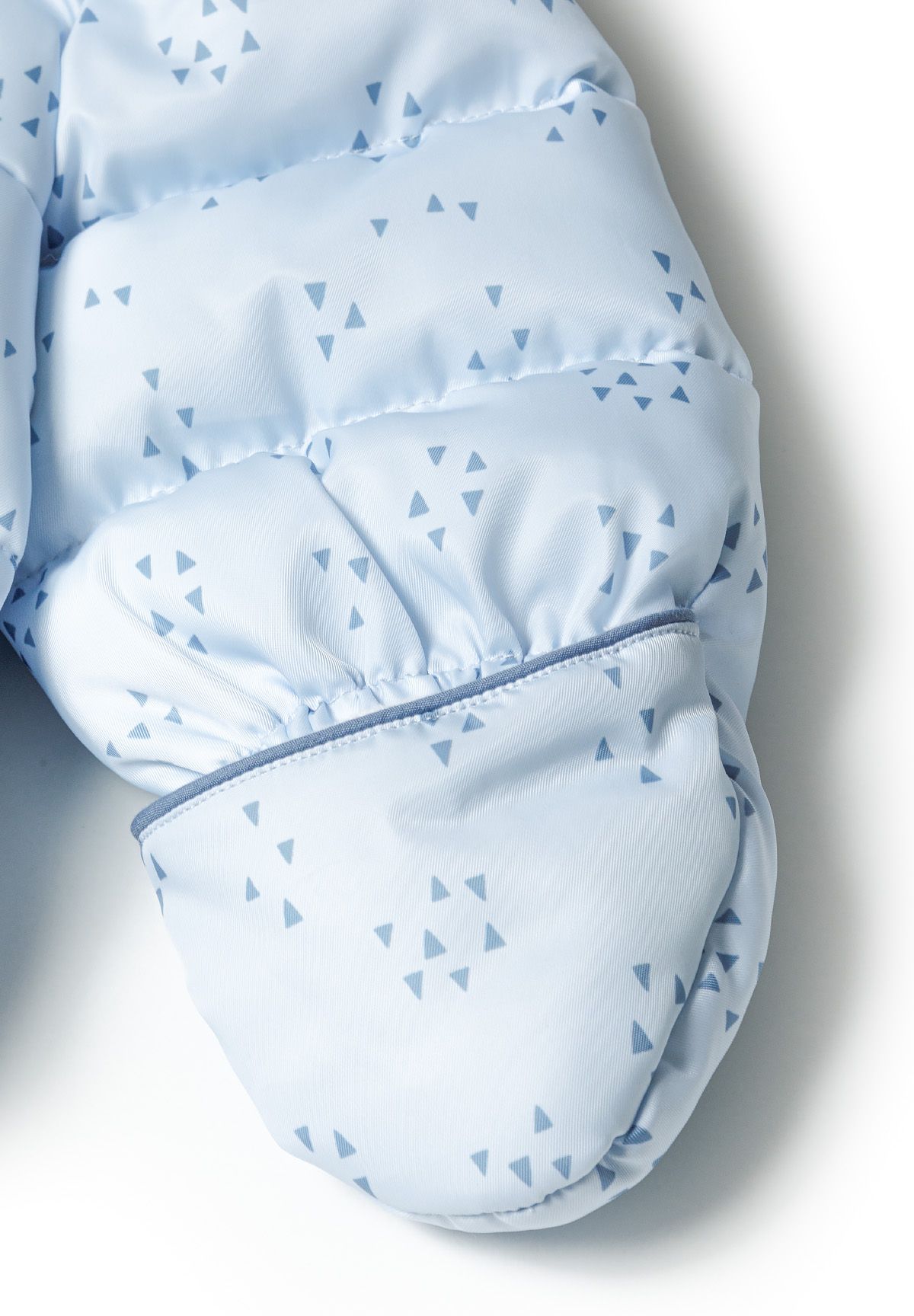 Pale blue padded baby snowsuit foot cover with small blue triangle motifs.
