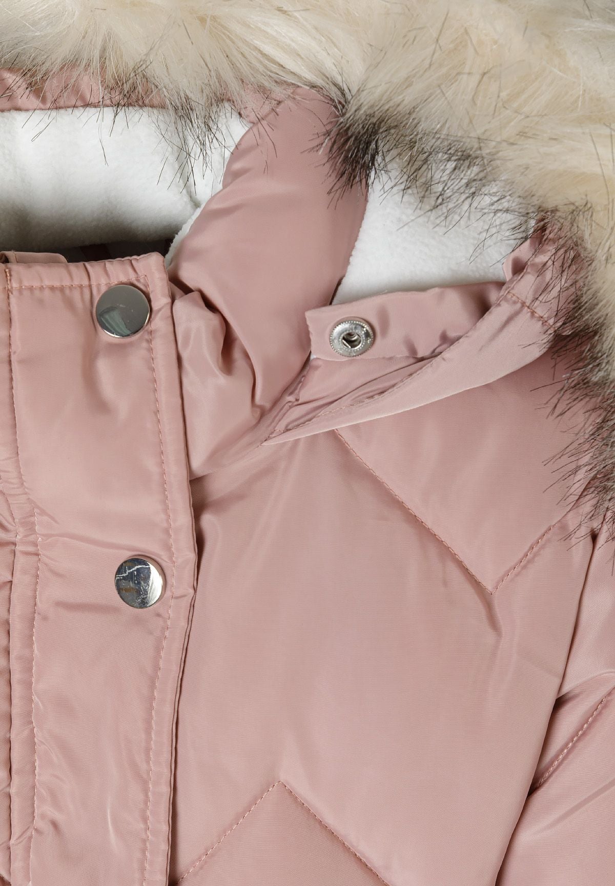 Close-up of cream fluffy hood trim, white lining and shiny silver snaps on the pink coat collar.