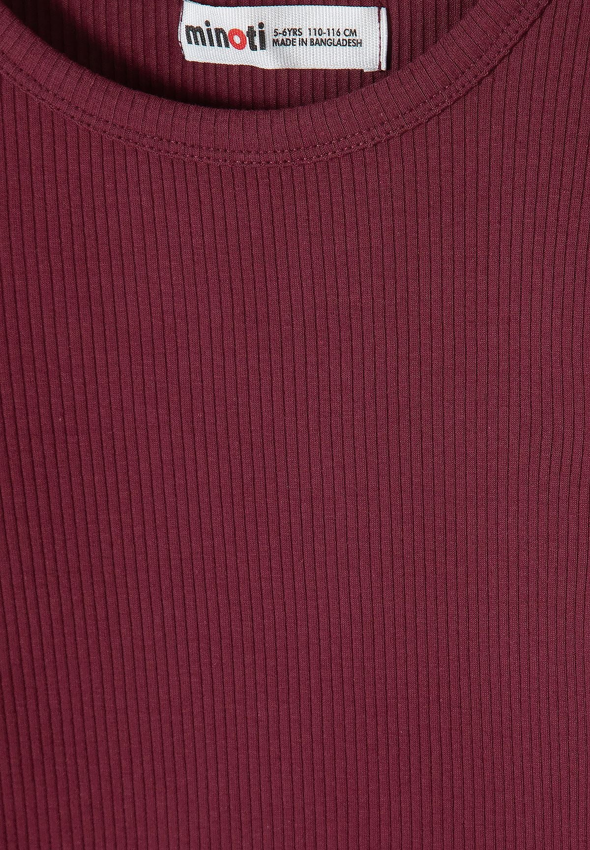 Close-up of fine vertical ribs and round neck on burgundy dress.