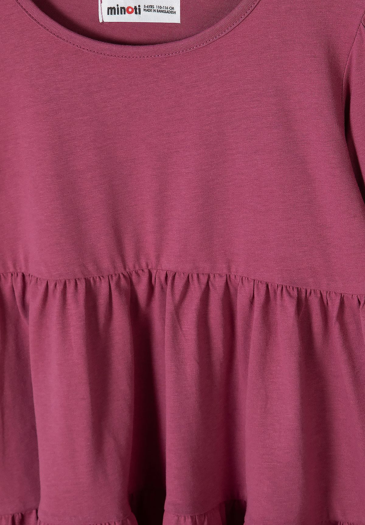 Close-up of berry-pink dress showing round neckline and gathered waist seam.