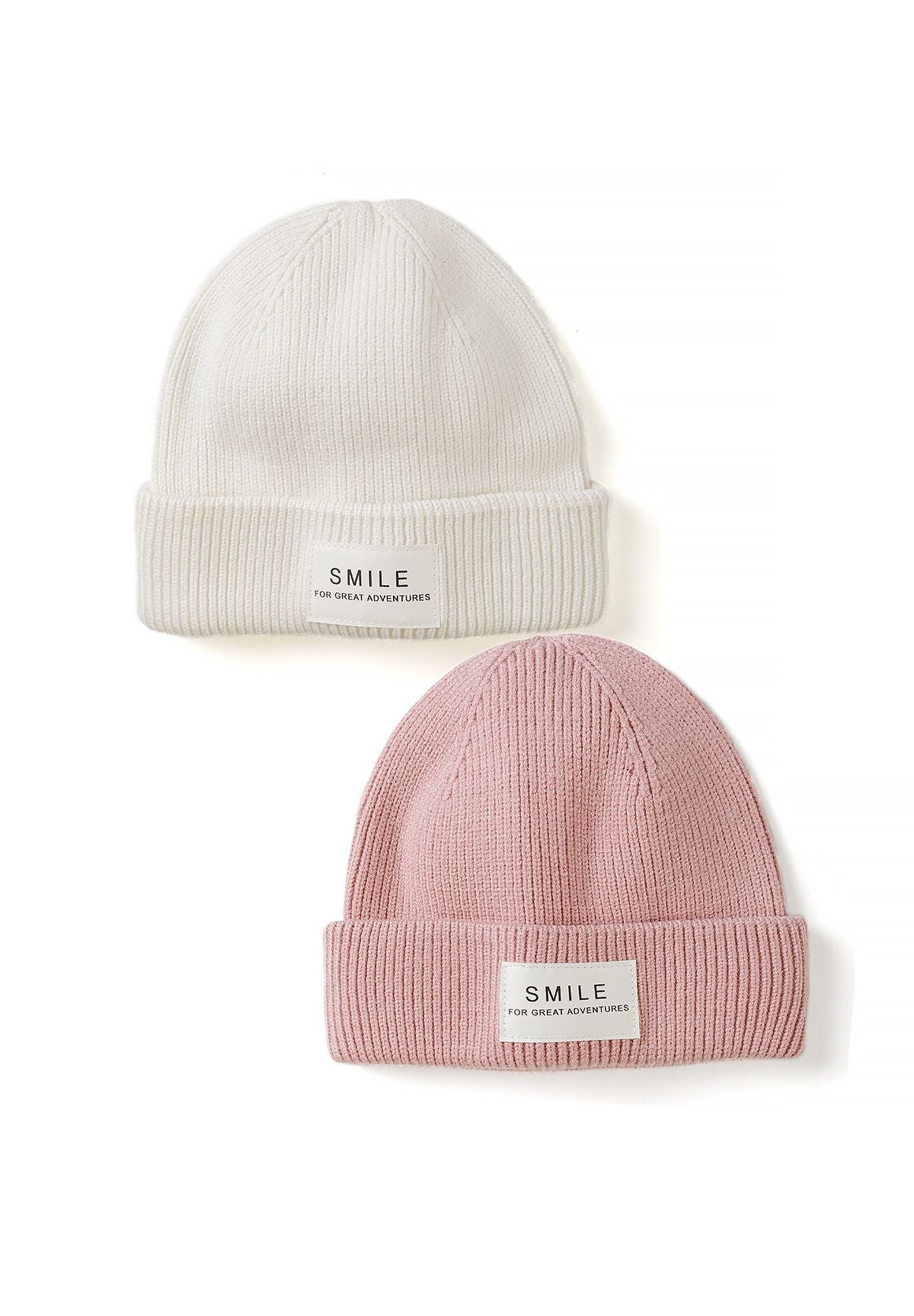 Cream and dusty pink rib-knit beanies with folded cuffs and white SMILE labels, two-pack.