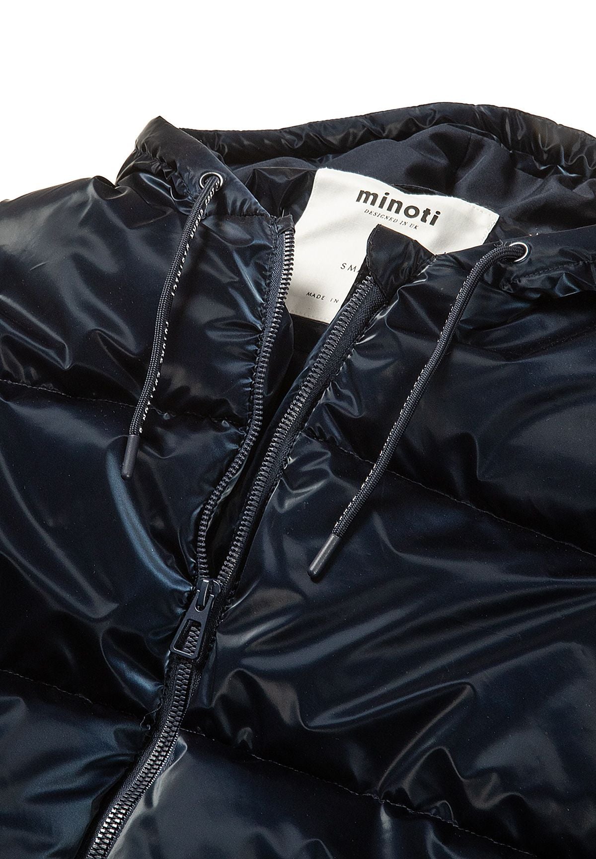 Close-up of the navy coat's front zip and two drawcords threaded through its padded hood.