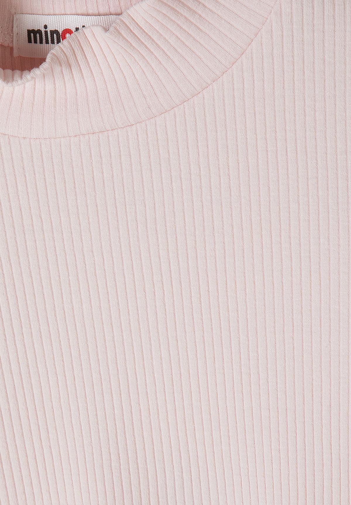 Close-up of pale pink vertical ribbing and the top's high neckband.