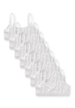 Seven plain white girls' crop tops with narrow straps and elastic underbands.