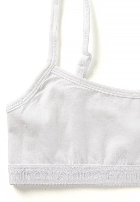 Detail of white crop top's adjustable strap, scoop neck and branded band.