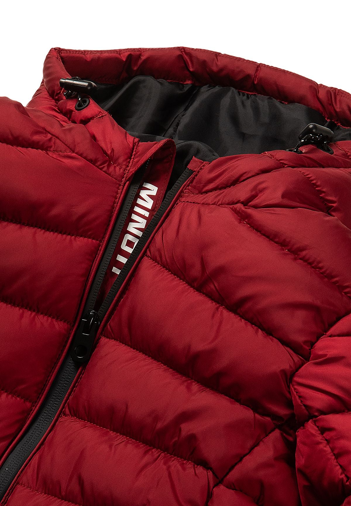 Close-up of the black-lined hood, cord toggles and front zip of the red puffer jacket.