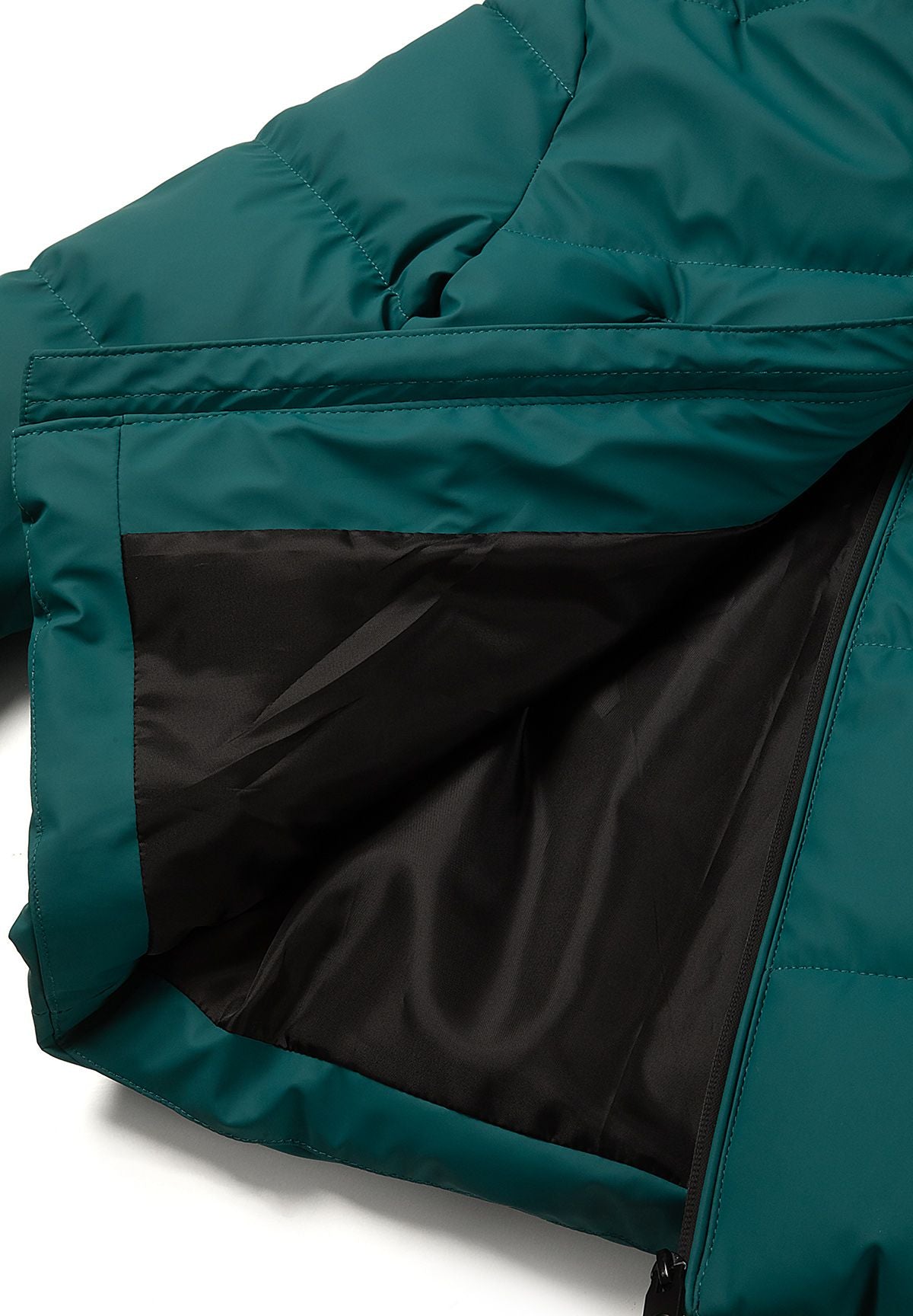 Inside view of the teal jacket showing smooth plain black body lining beneath the quilted shell.