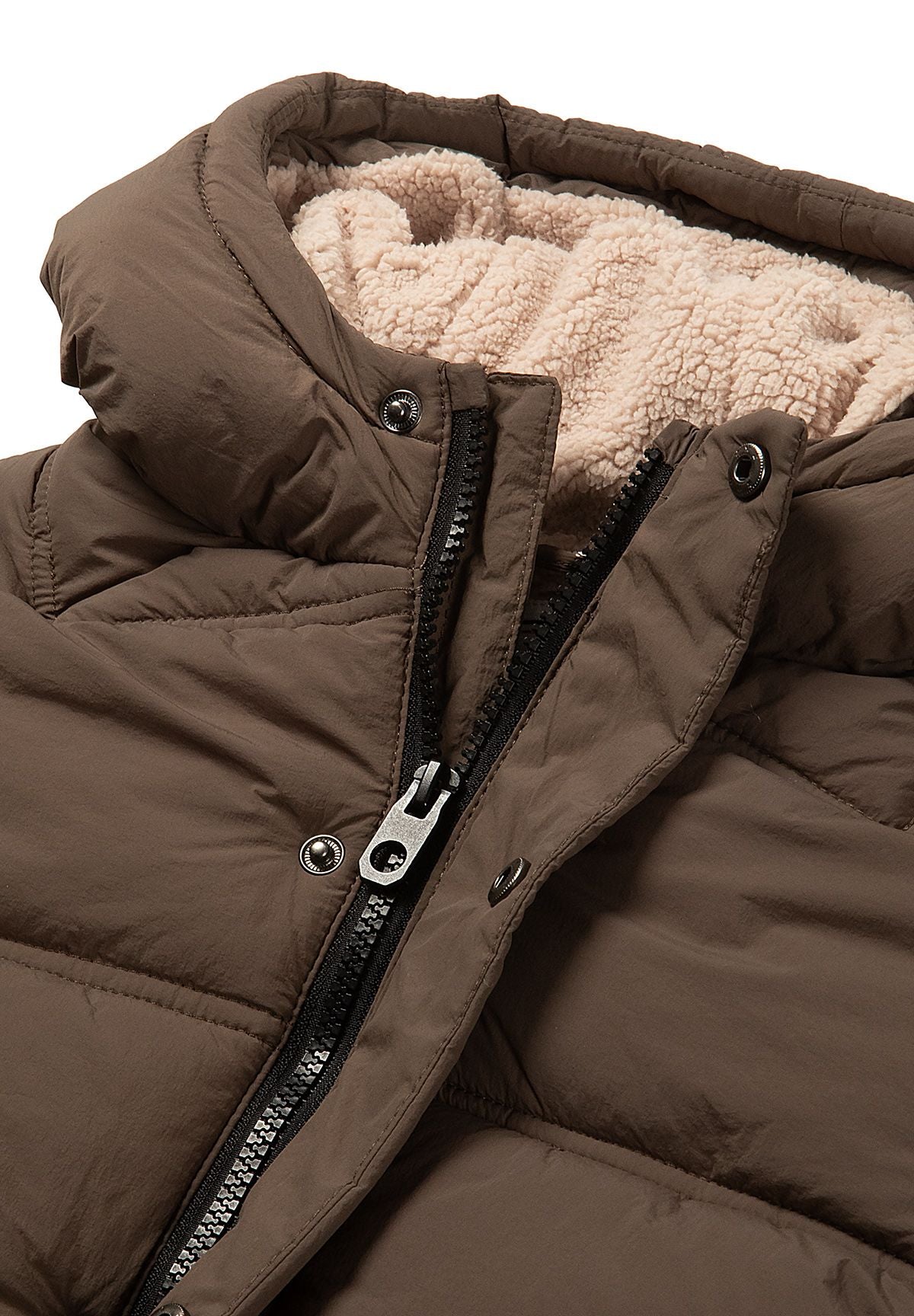 Close-up of the black zip, round snaps and beige teddy-lined hood on the brown jacket.