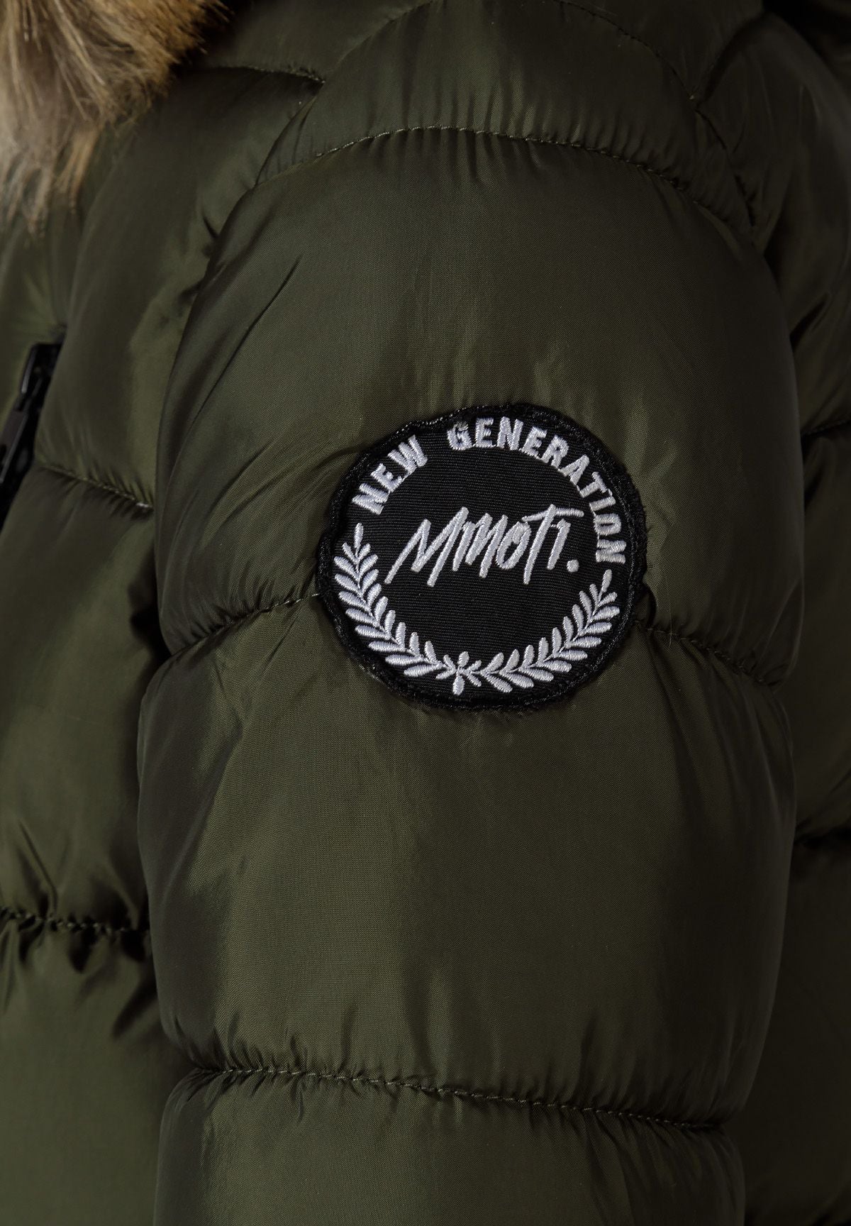 Close-up of the black NEW GENERATION MINOTI sleeve badge on an olive khaki padded parka.