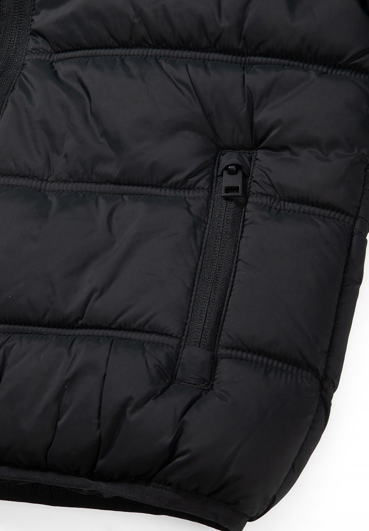 Black zipper set into an angled side pocket of the quilted puffer jacket.