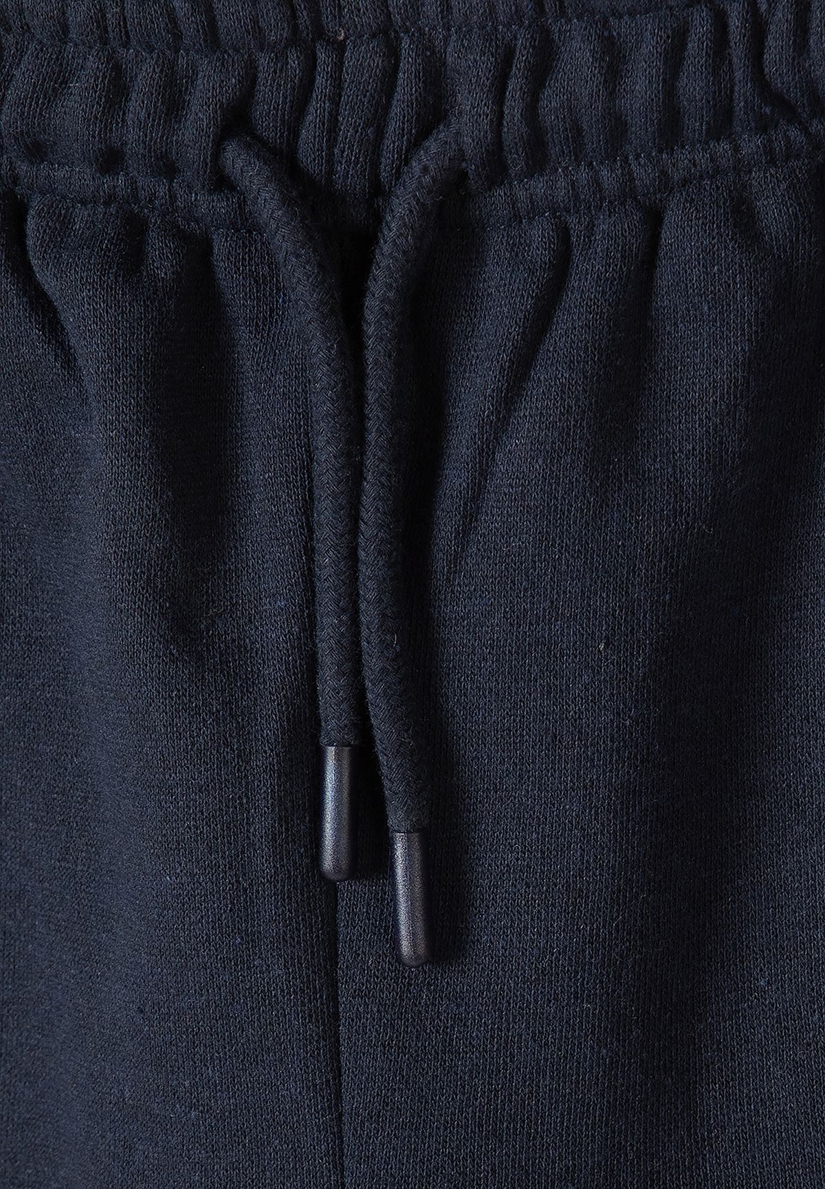 Navy joggers waist detail with braided drawcord and capped ends.
