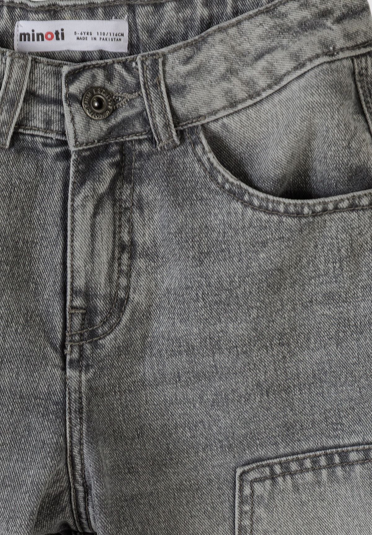 Close-up of washed grey carpenter jeans waist with button, belt loop and curved front pocket.