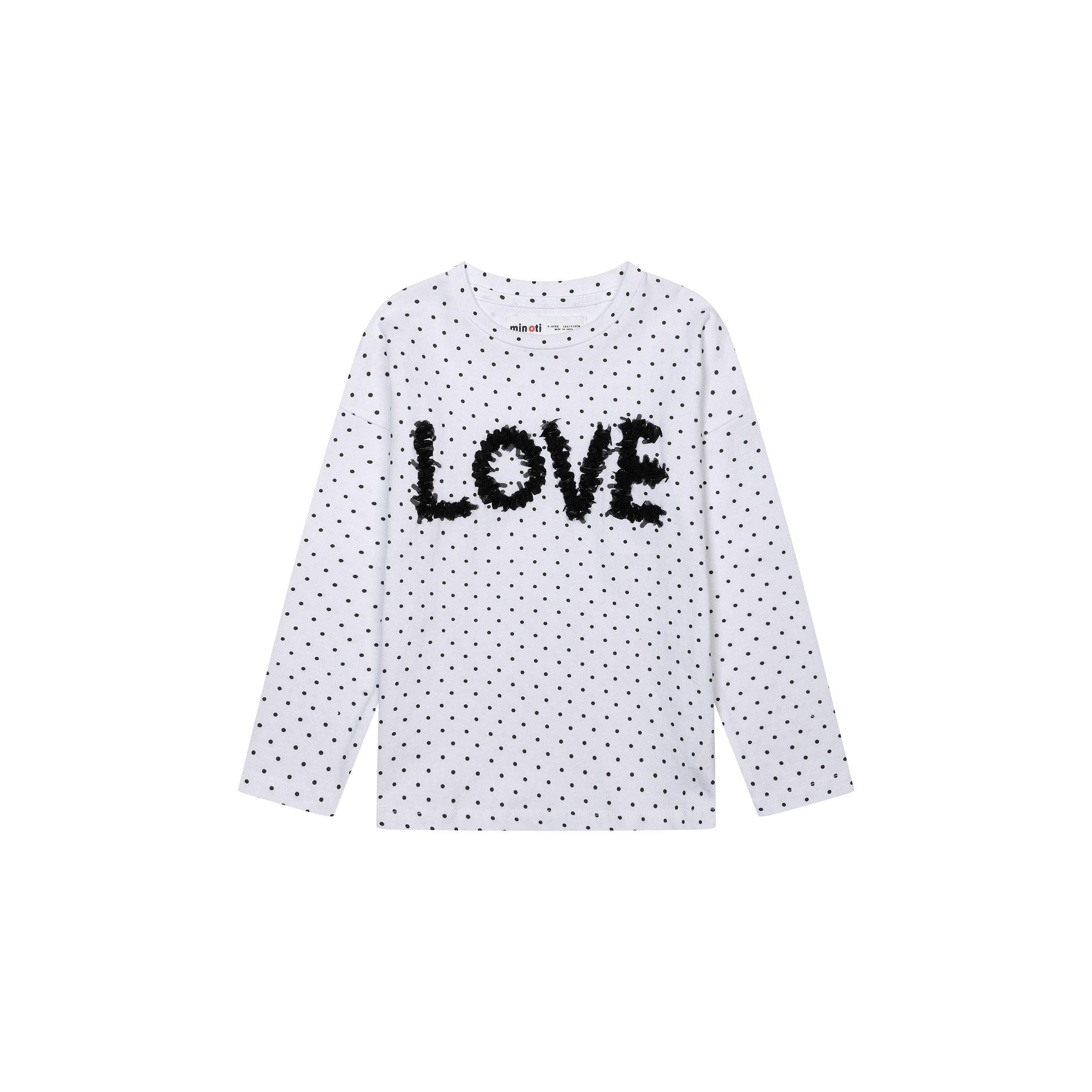 Back view of white long sleeve top with navy polka dot pattern laid flat on white background