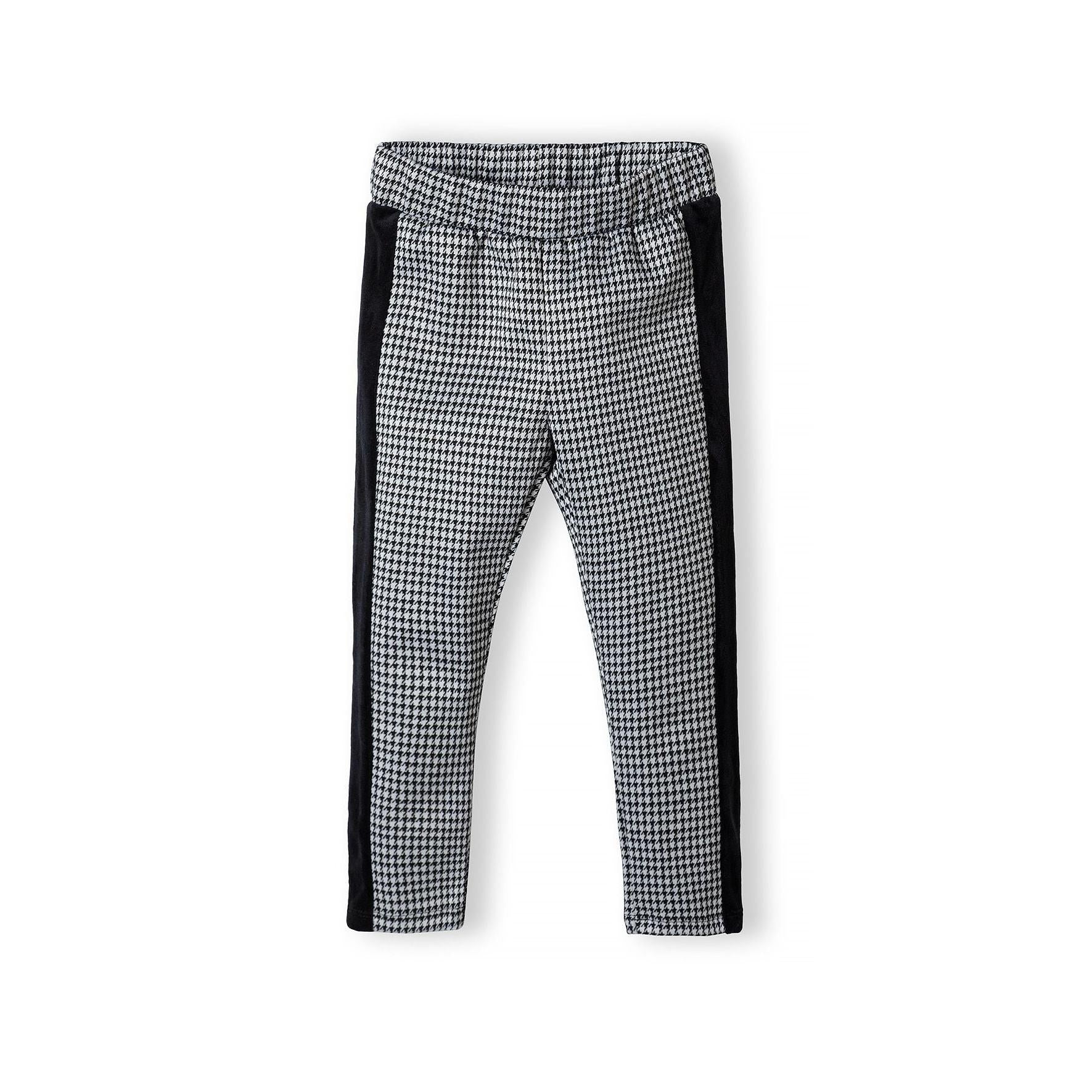 Black and white dogtooth pattern leggings laid flat showing houndstooth design and black side panels on white background