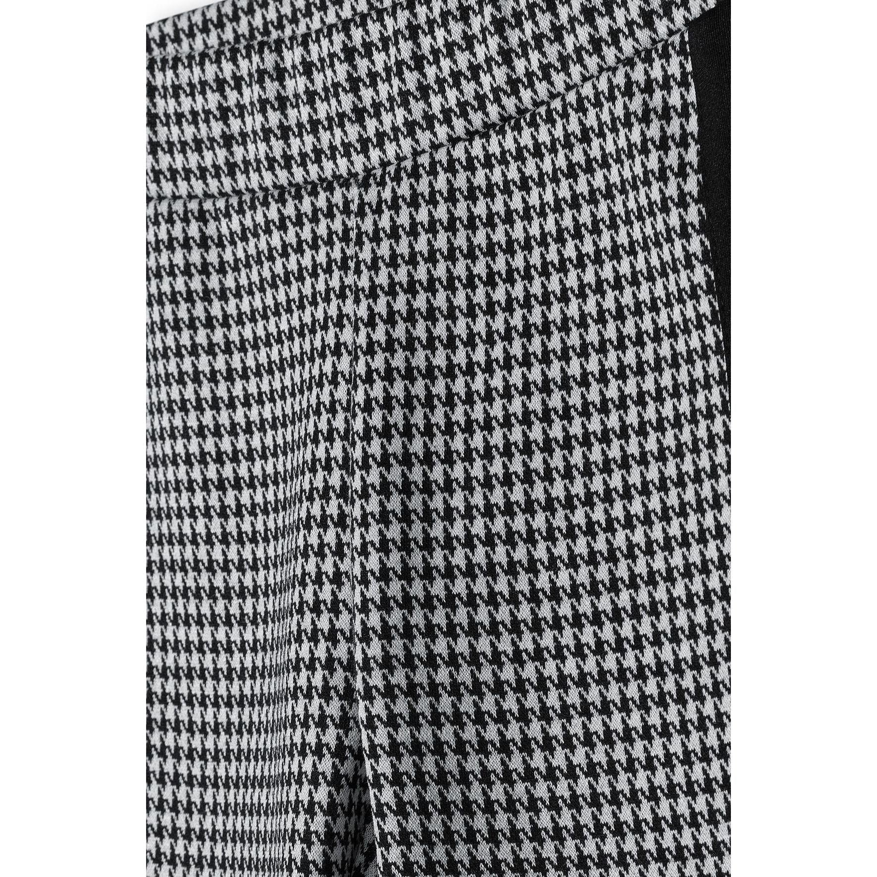 Close-up detail of black and white houndstooth dogtooth pattern fabric texture showing intricate weave design