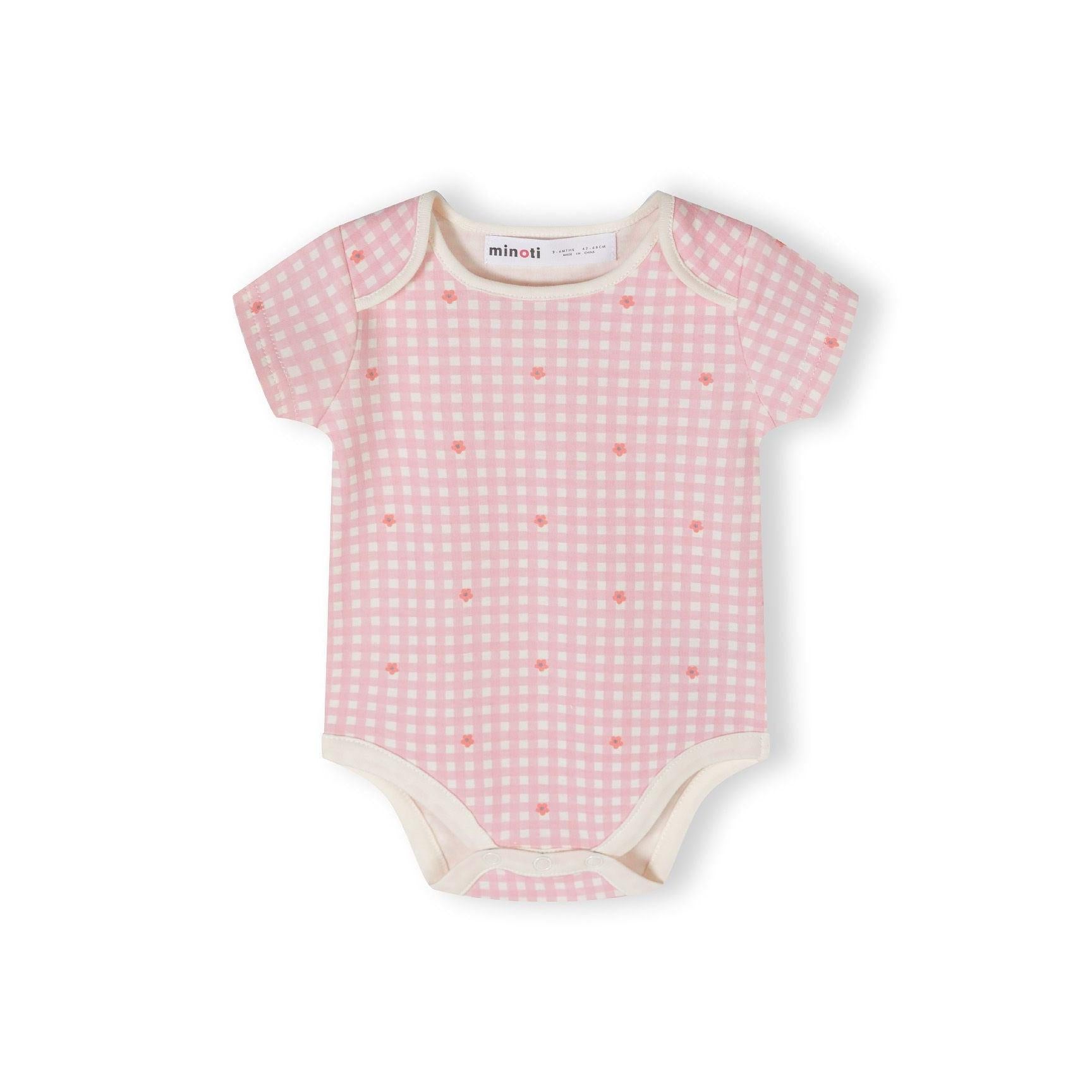 Single light pink short sleeve bodysuit with white daisy flower print pattern scattered across the fabric on white background