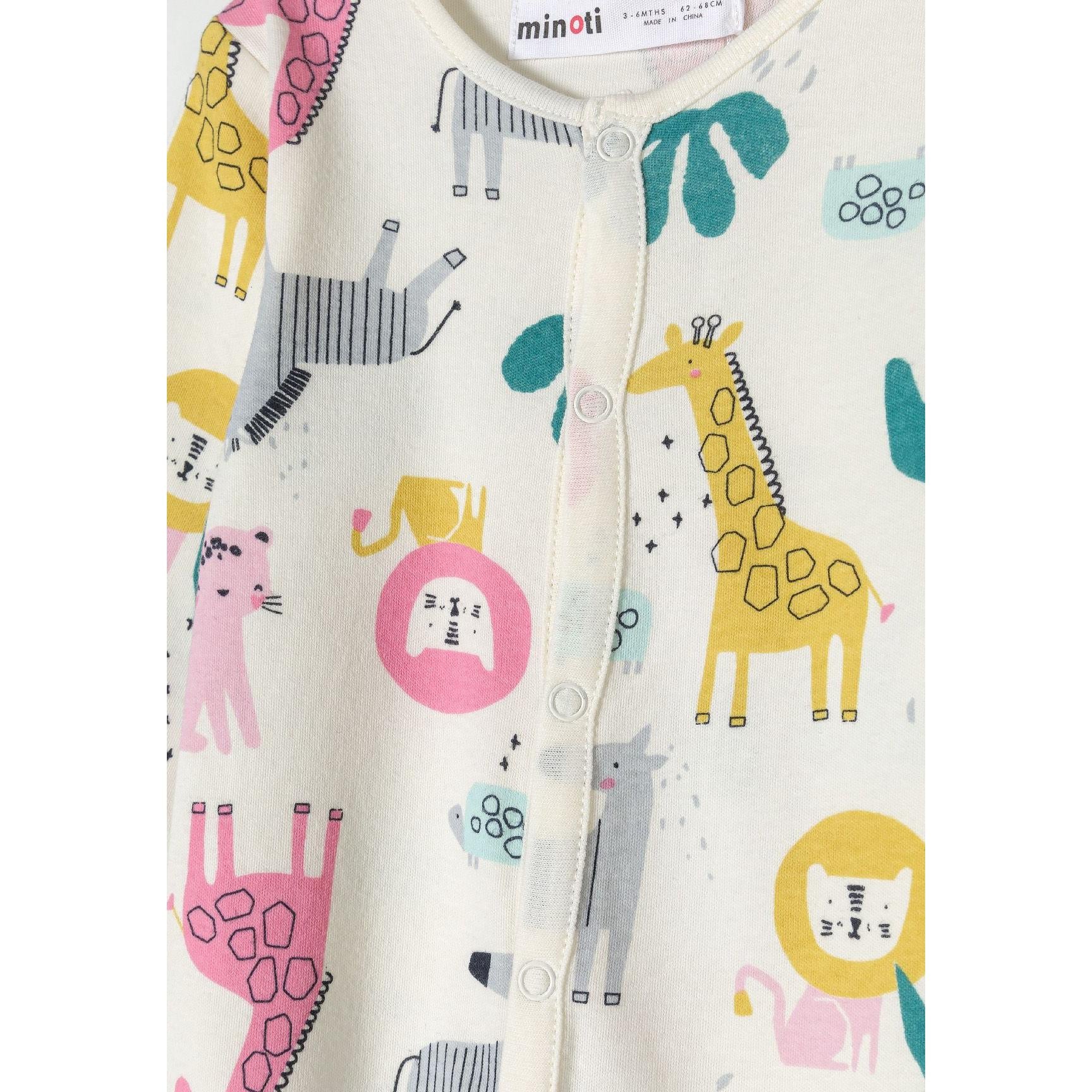 Close-up detail of pink sleepsuit showing snap button closure and embroidered lion character with blonde mane and floral elements on chest