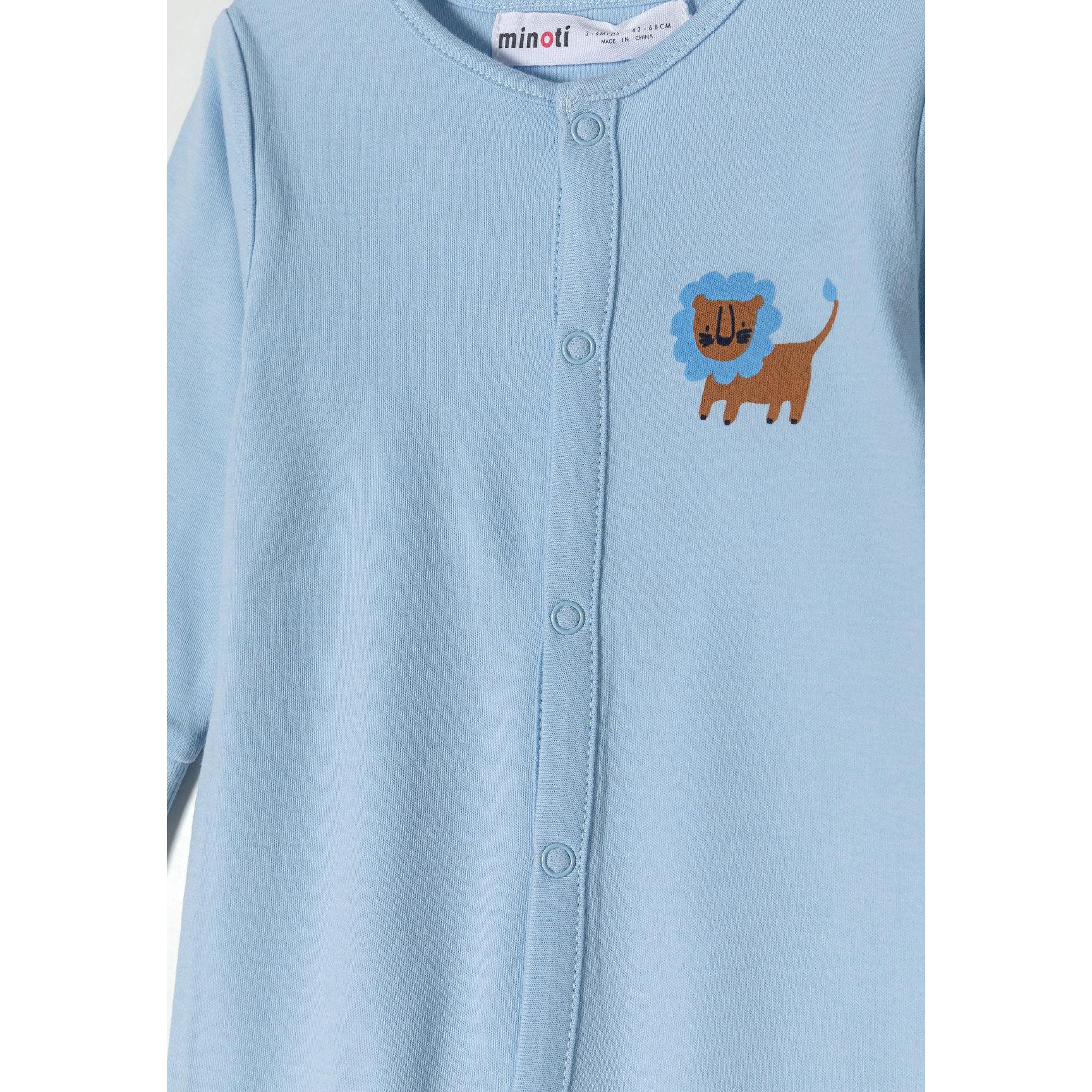 Close-up detail of white sleepsuit showing safari print with blue elephants, brown giraffes, navy geometric shapes and snap button fastenings down the front