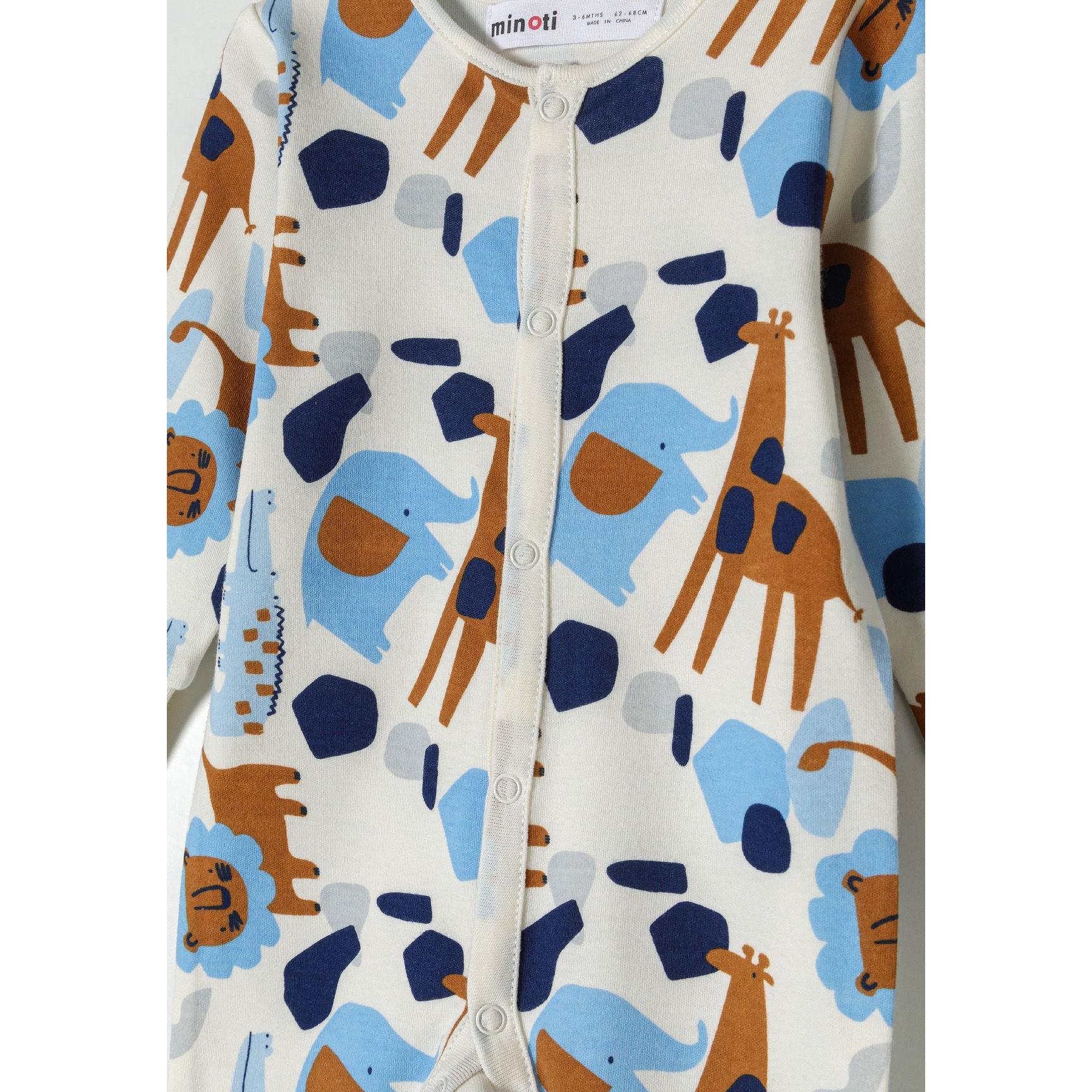 Close-up detail of white sleepsuit showing safari print with blue elephants, brown giraffes, navy geometric shapes and snap button fastenings down the front