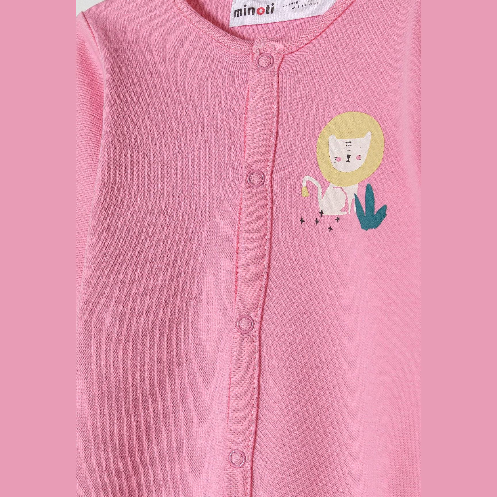 Close-up detail of pink sleepsuit showing lion applique and snap buttons