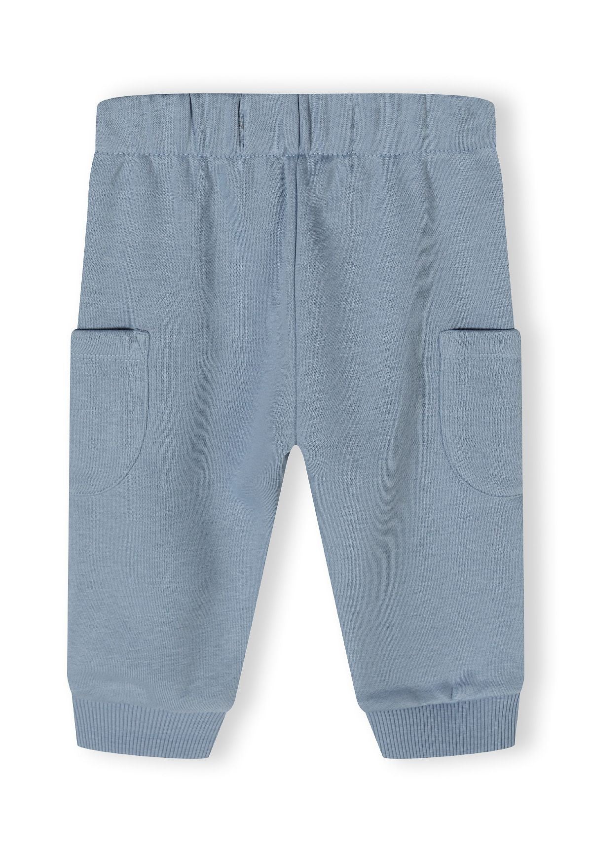 Detail of blue jogger trousers with elasticated waistband and side pockets.