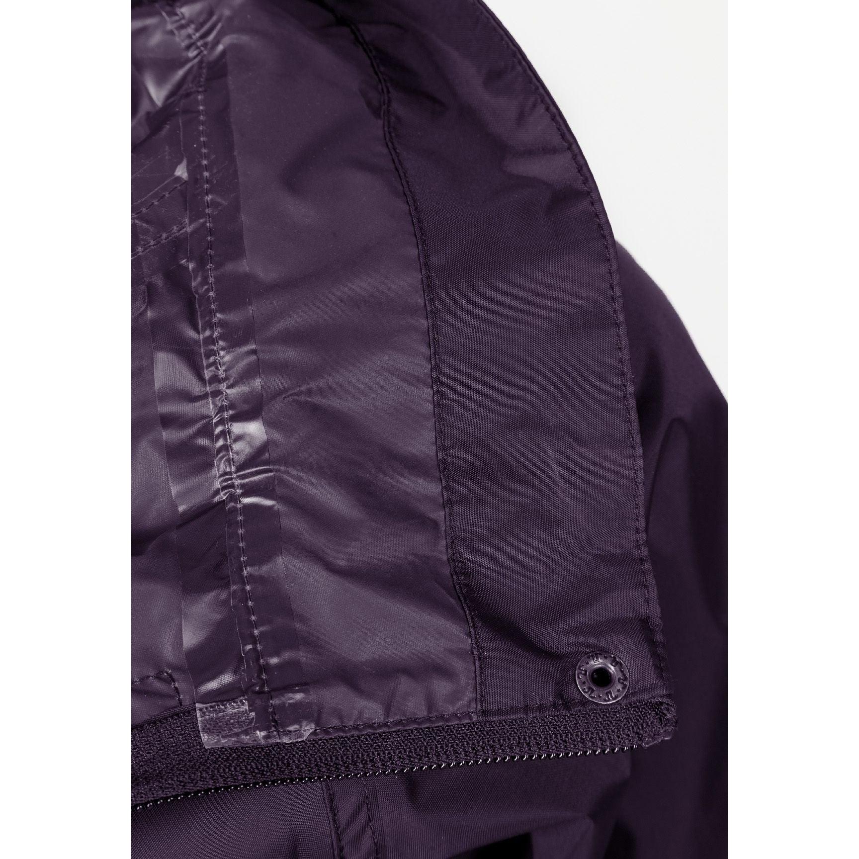 Close-up detail of purple waterproof jacket showing pocket construction and fabric texture