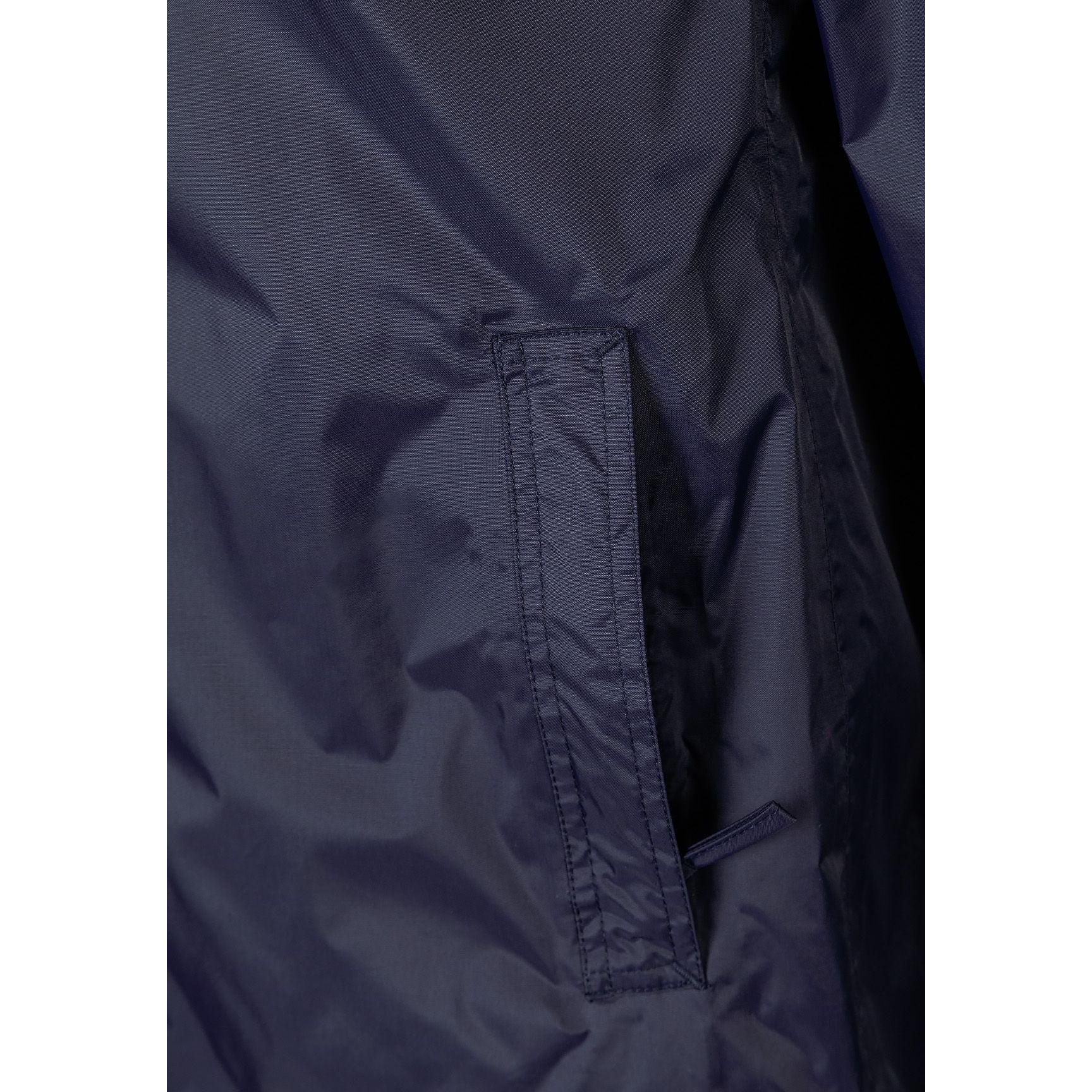 Close-up detail of navy jacket interior showing internal zip pocket and waterproof lining construction