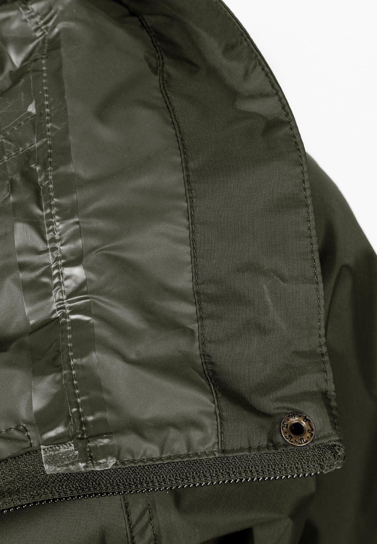 Detail of a khaki waterproof jacket showing the hidden hood and zip closure.
