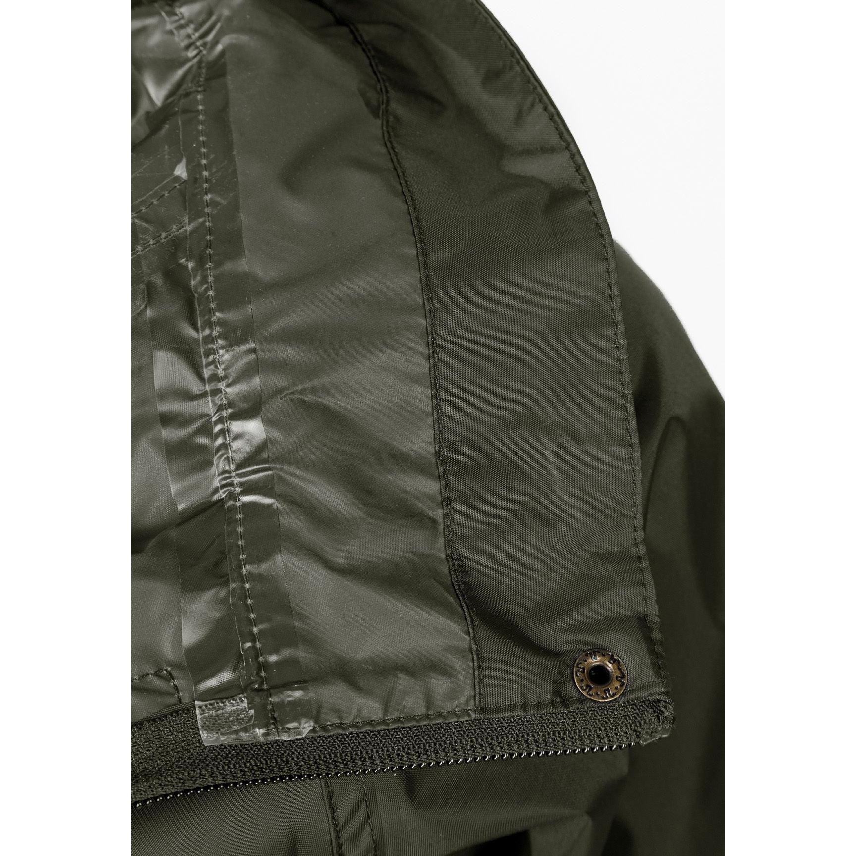 Close-up interior view of khaki jacket showing waterproof lining and internal construction details with seamed edges