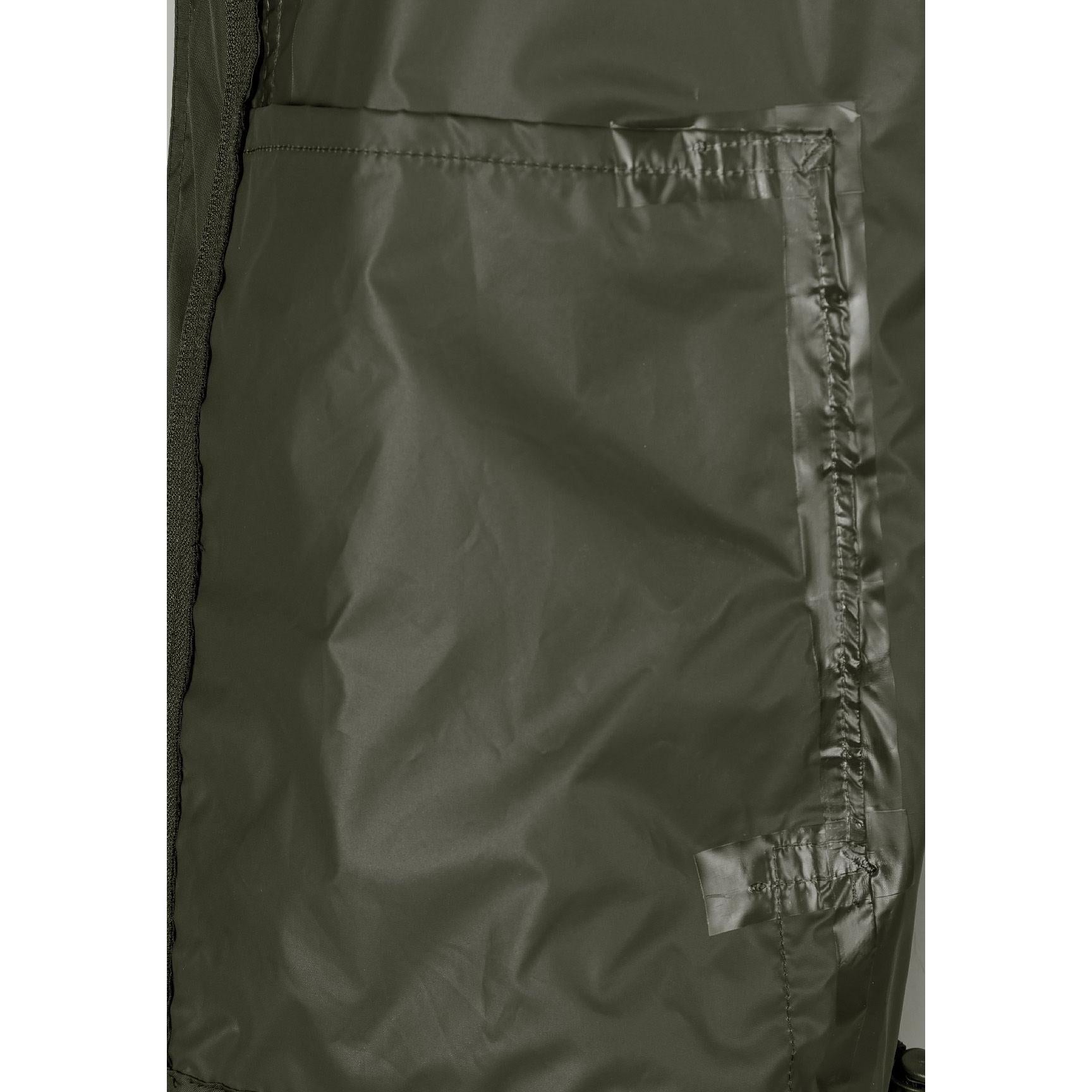 Close-up interior view of khaki jacket showing waterproof lining and internal construction details with seamed edges