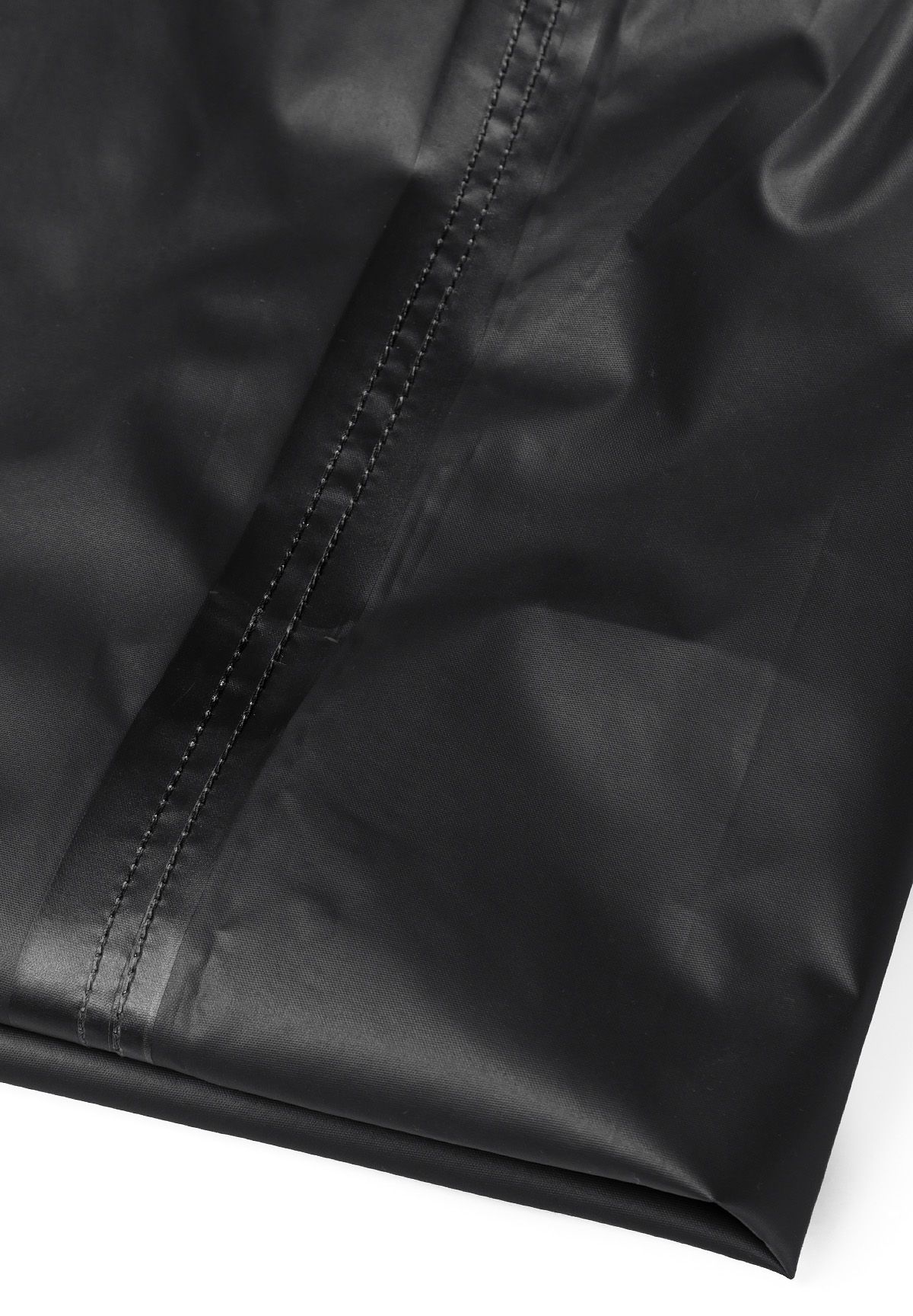 Detail of black waterproof overpants with visible stitching.
