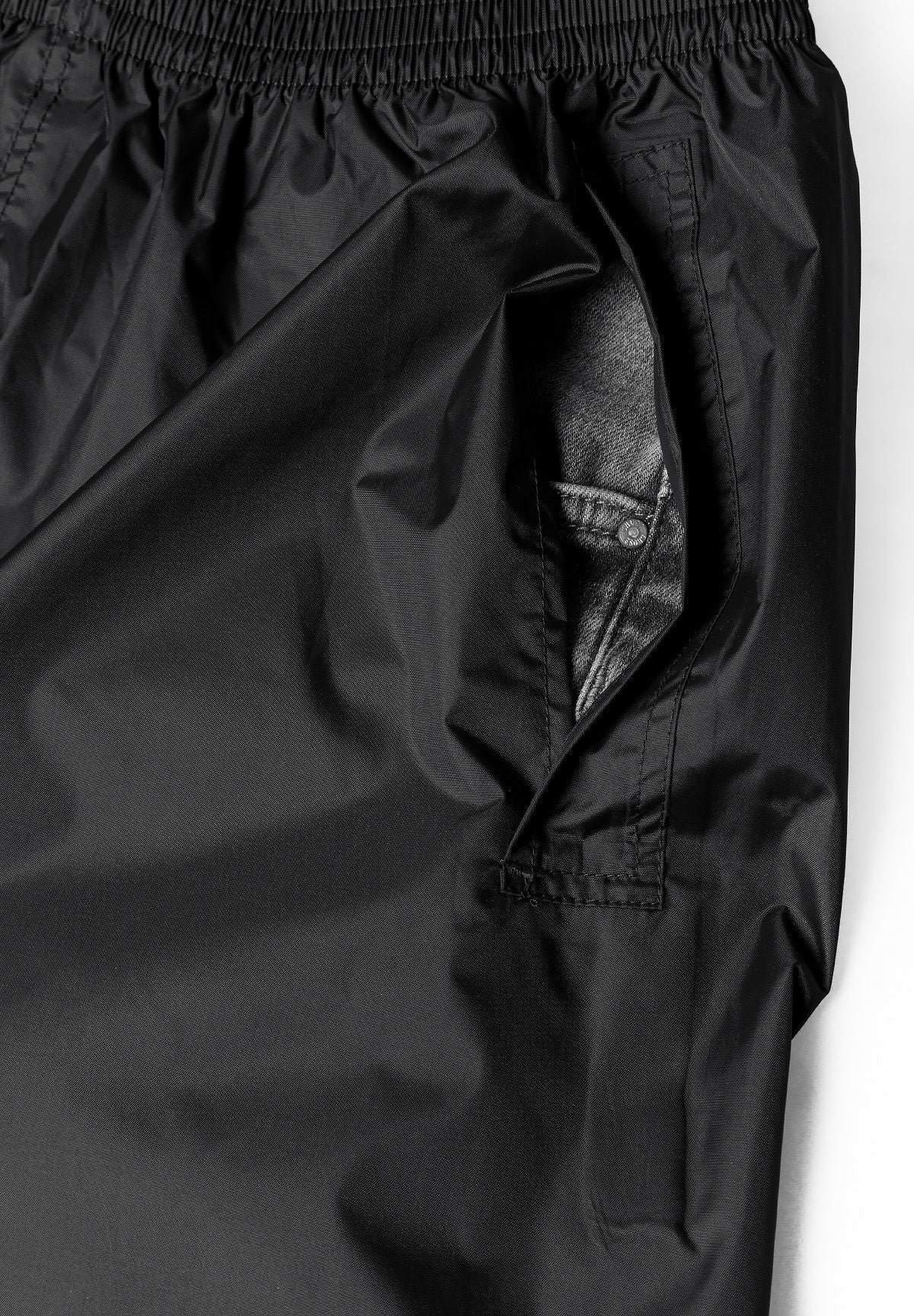 Black packaway overtrousers, side access opening over jeans.