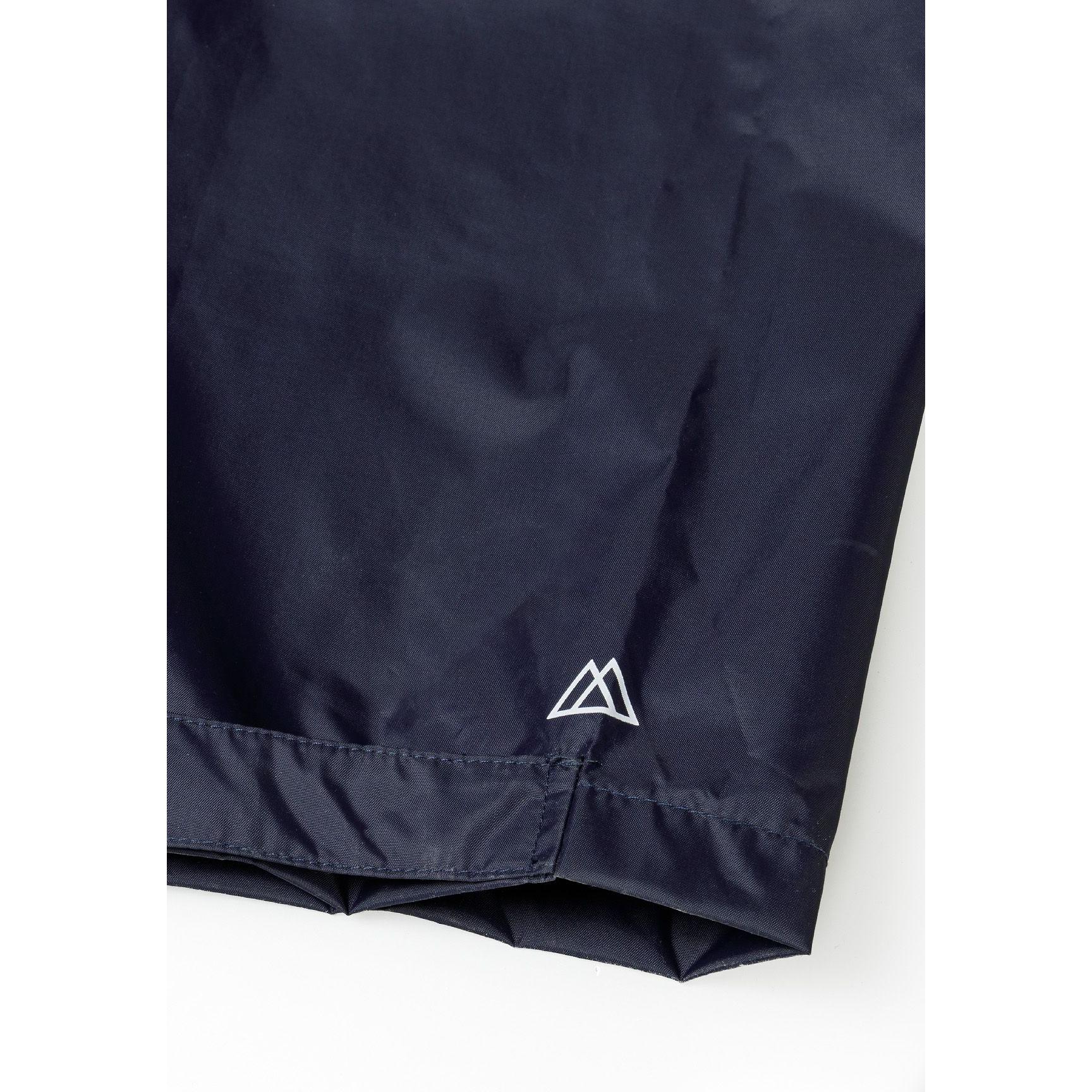 Close-up detail of navy waterproof overpants showing elastic waistband and waterproof fabric texture