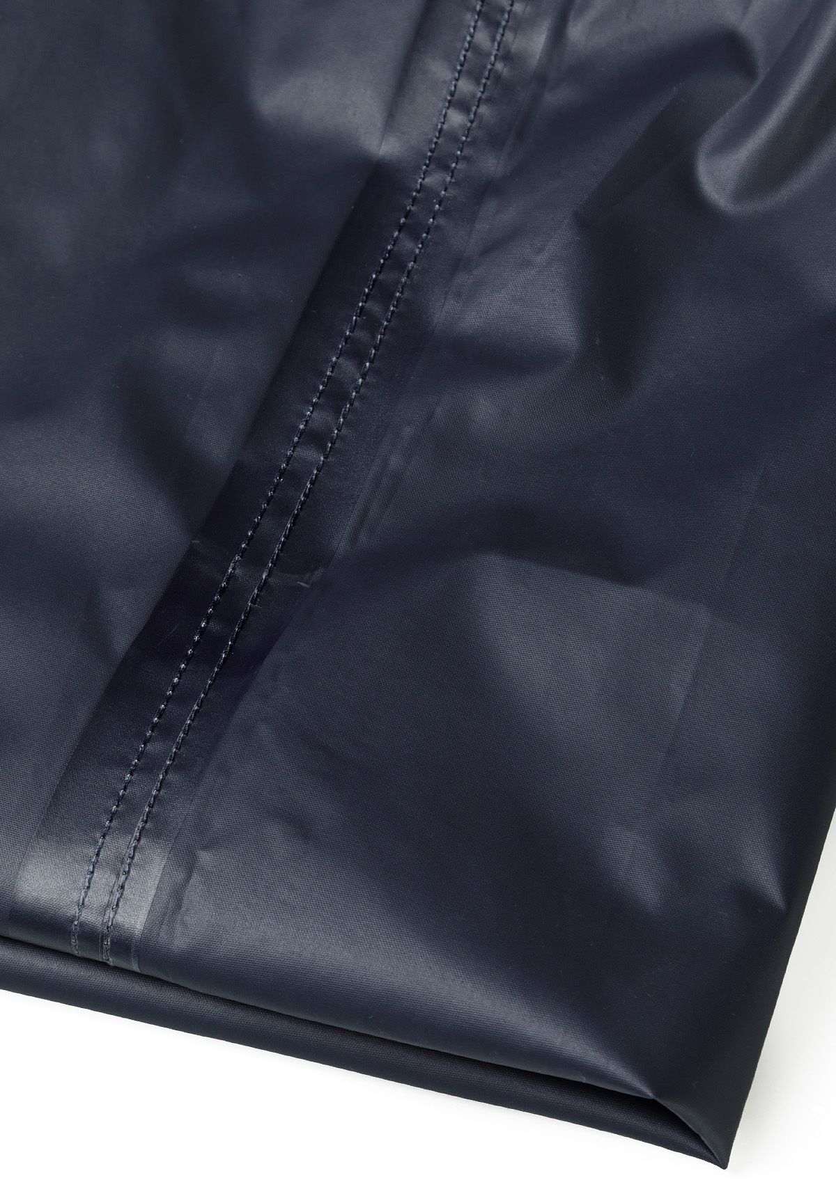 Detail of navy waterproof overpants with smooth finish and stitching.