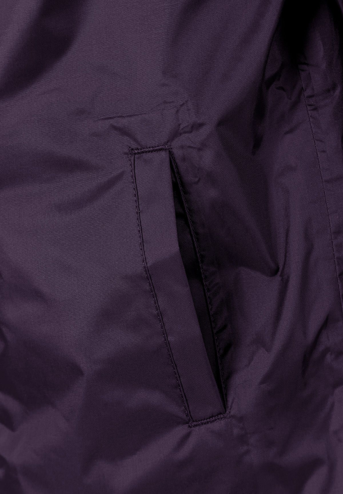 Detail of a purple kids packaway waterproof jacket showing a side pocket.
