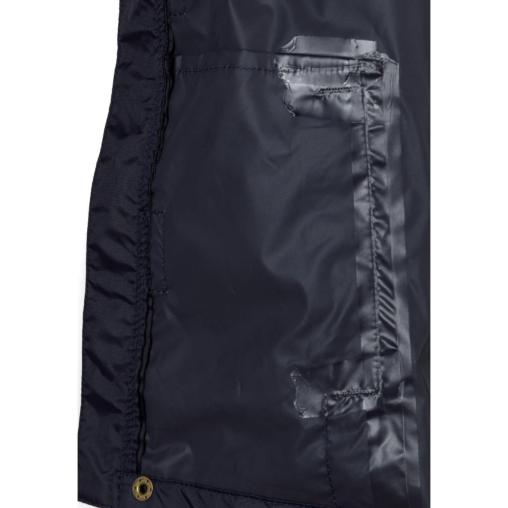 Interior detail view showing navy lining with internal pocket and zip details of the packaway waterproof jacket