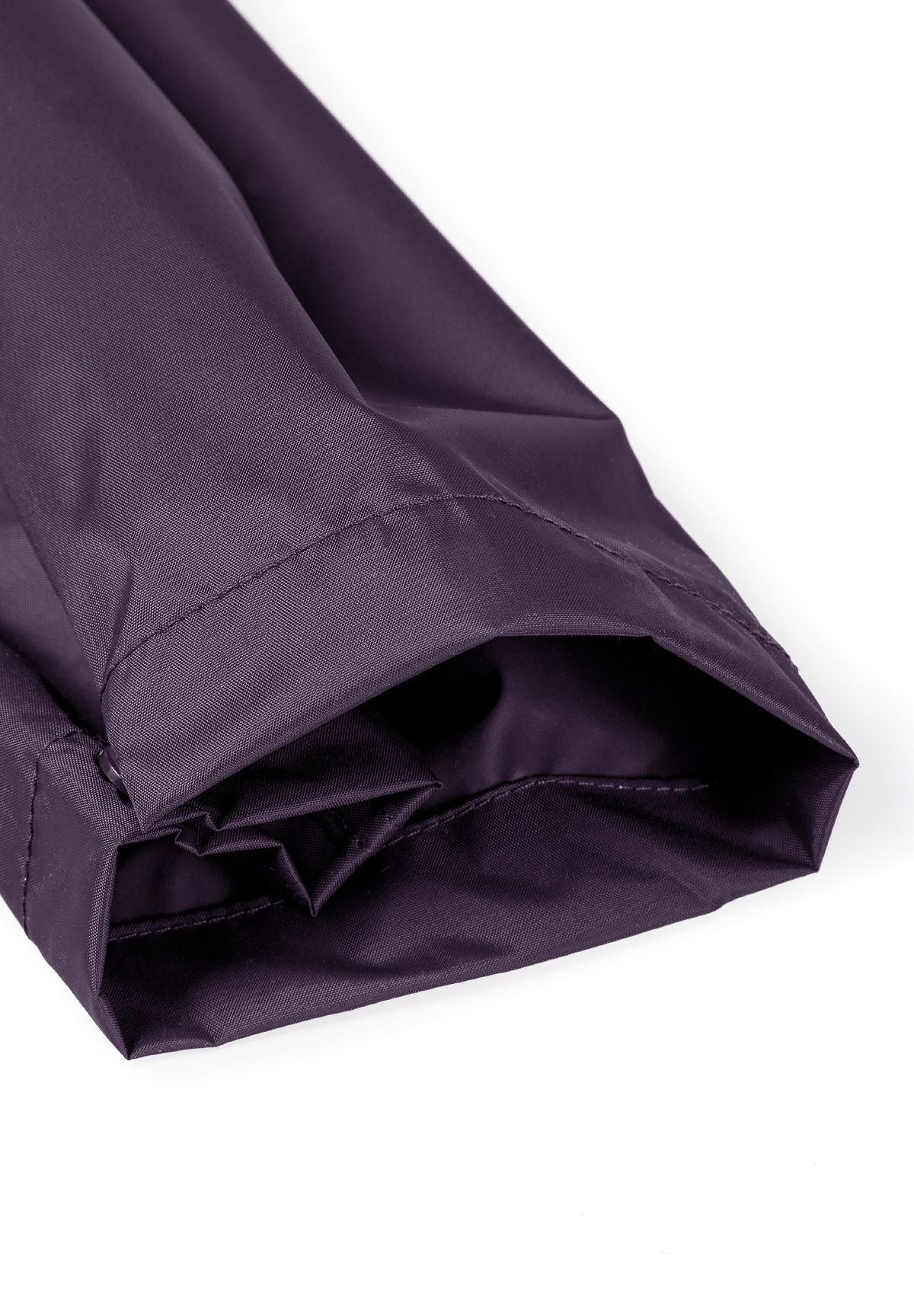 Detail of purple waterproof overpants with elasticated cuffs.