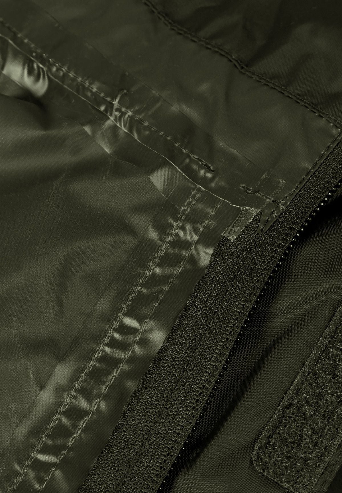 Close-up of the inside seam on the khaki packaway hooded jacket.
