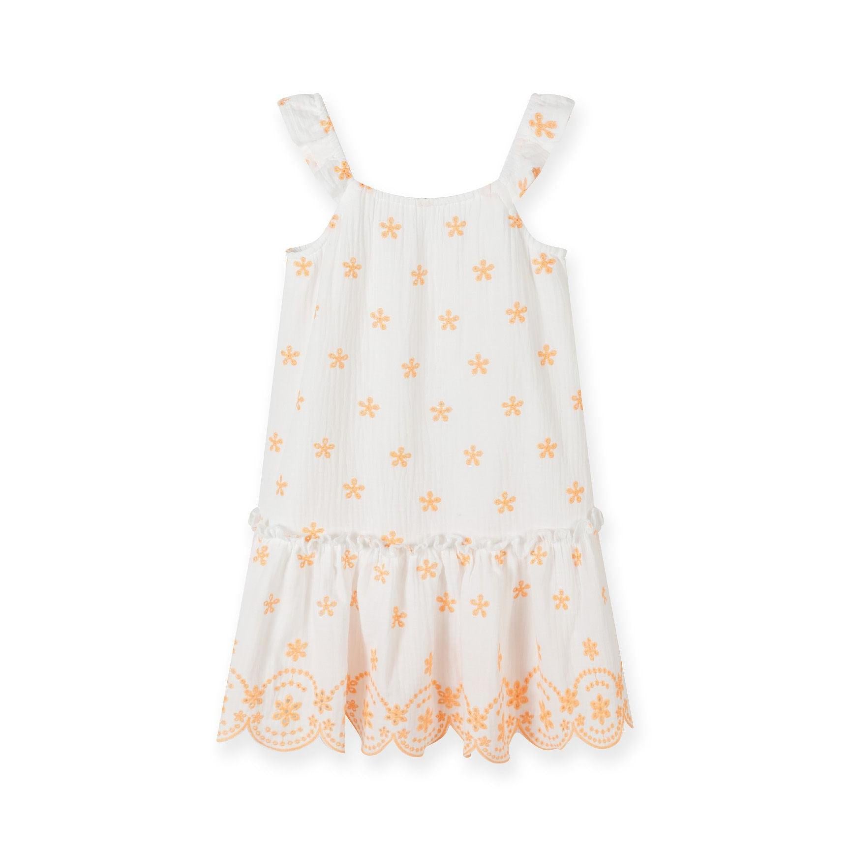 White cotton muslin dress with orange floral embroidery laid flat showing flutter straps, scalloped embroidered hem and all-over pattern detail