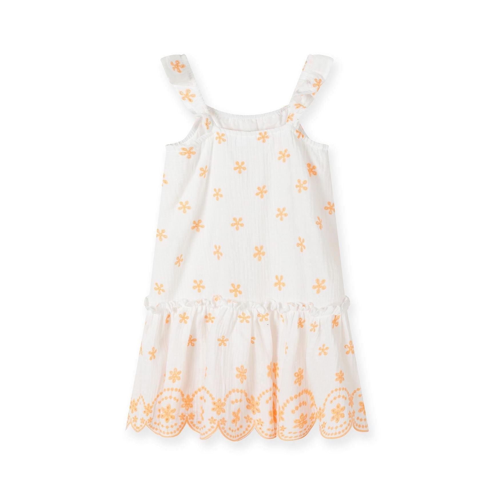 White cotton muslin dress with orange floral embroidery laid flat showing flutter straps, scalloped embroidered hem and all-over pattern detail
