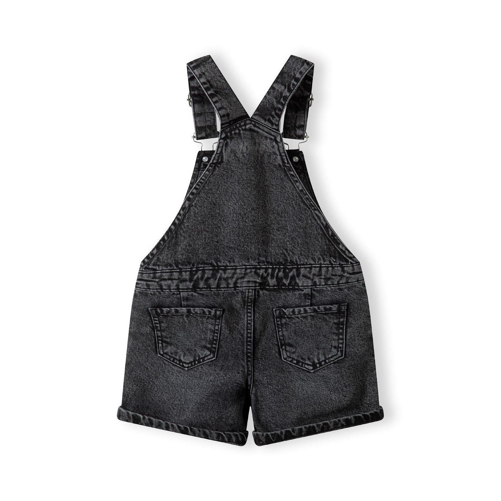 Back view of black denim dungarees showing adjustable straps and rear pockets on white background