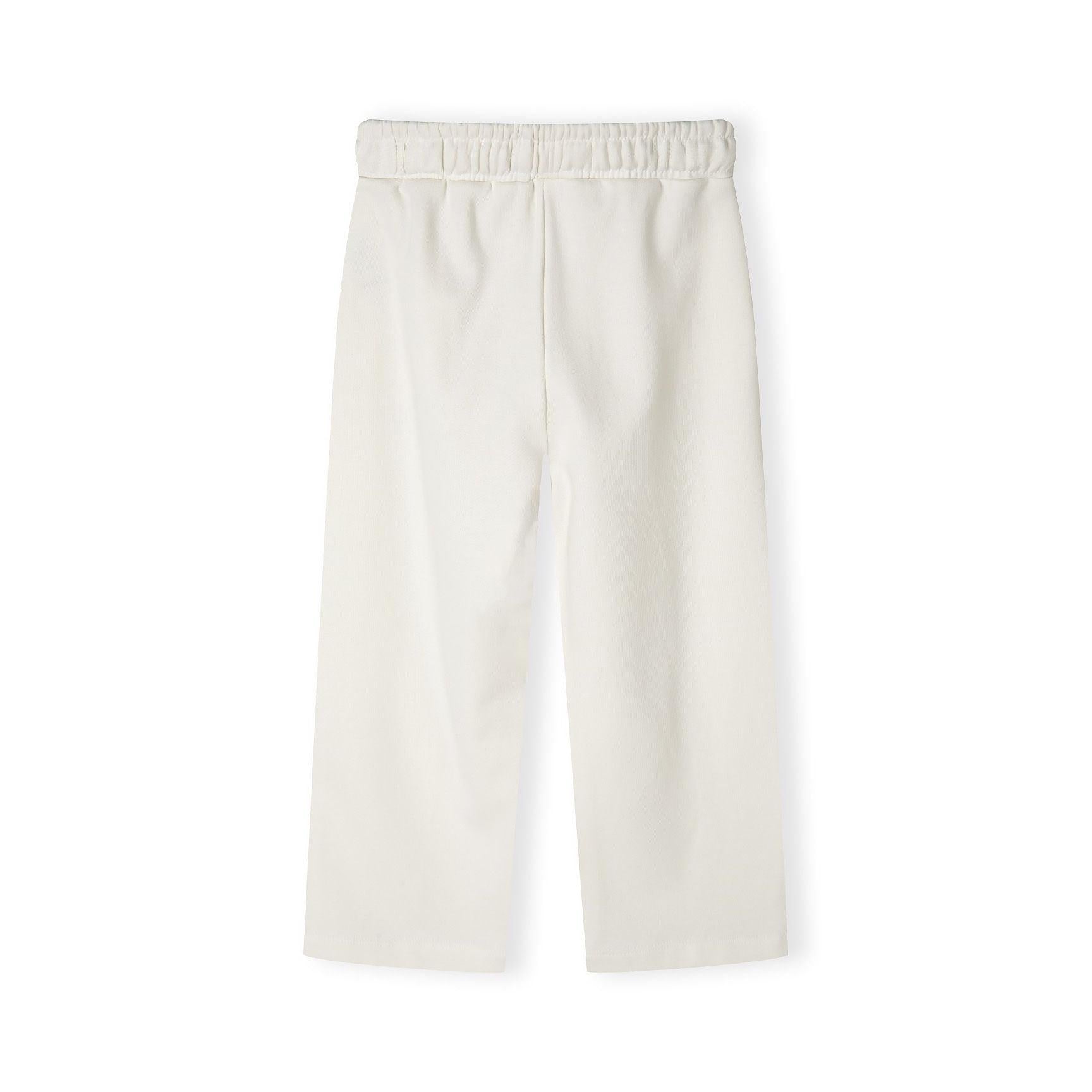 Close-up detail of cream joggers showing blue vintage-style text print reading 'USA 1967' with memories script text