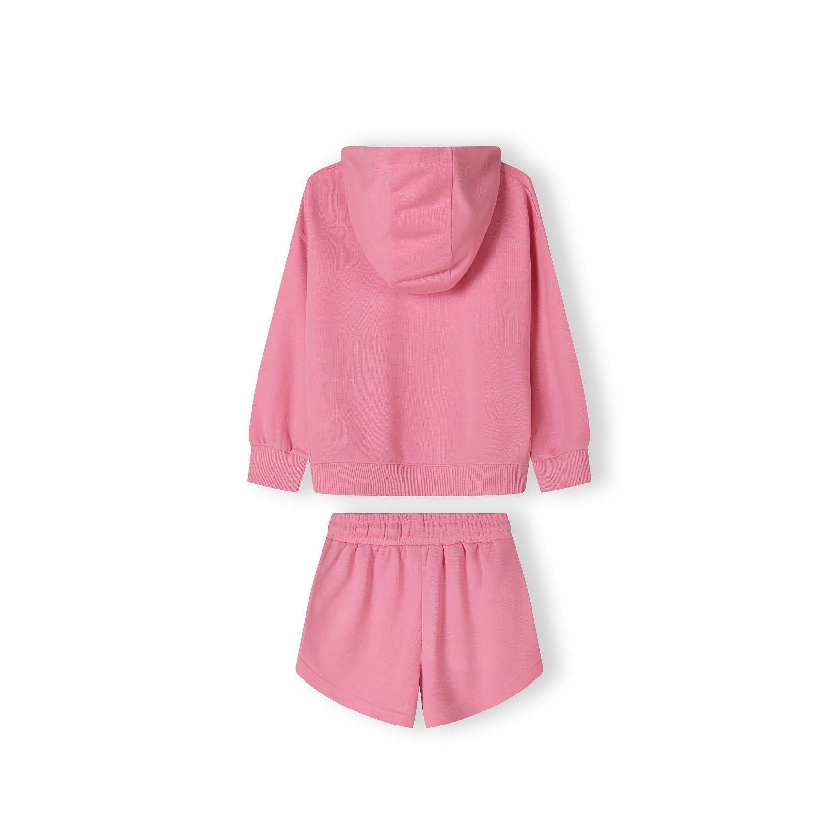 Close-up detail of pink shorts showing side pocket with 'Paris TeamGirl' text printed along the seam