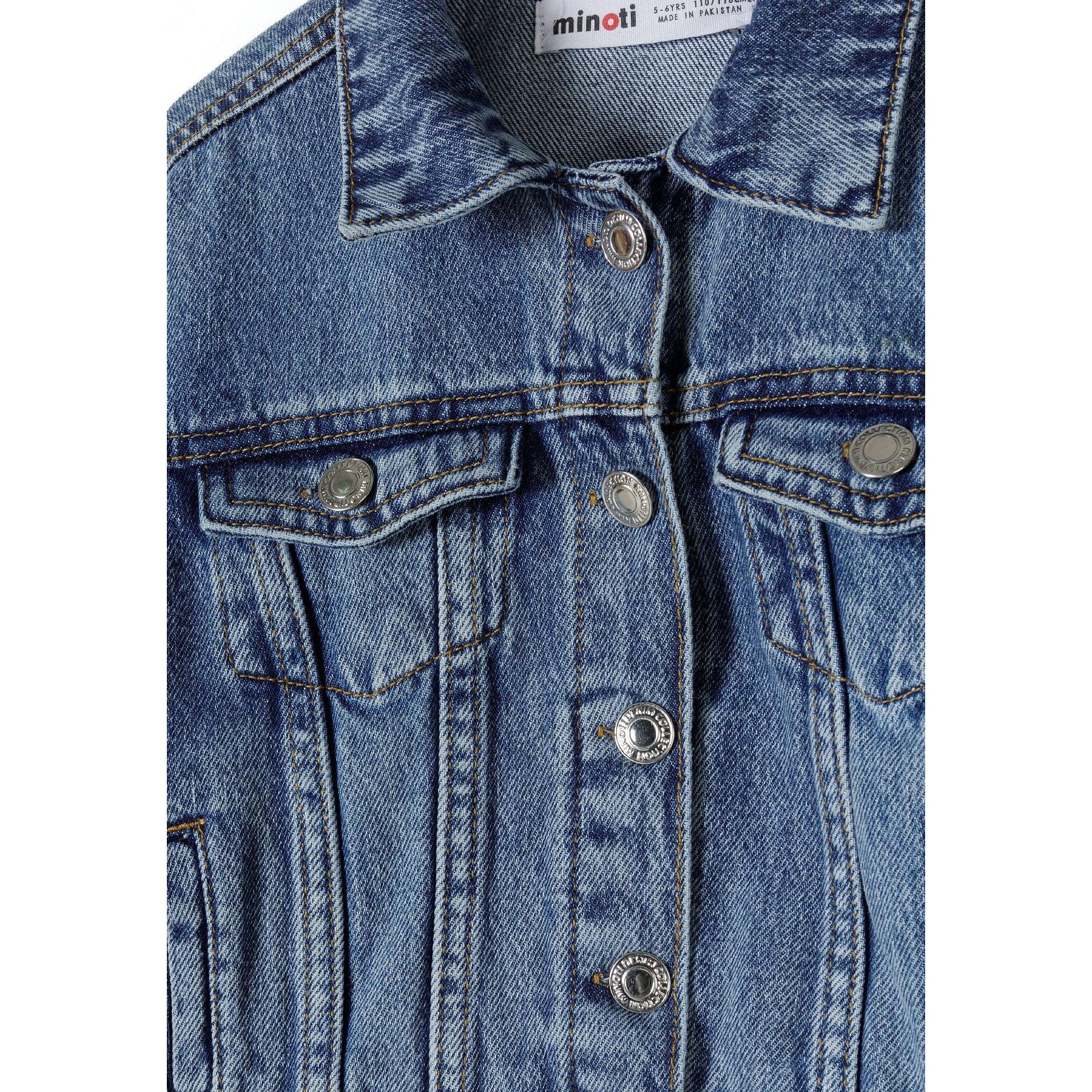 Close-up detail of navy denim jacket showing collar, button closure, chest pockets and Minoti brand label