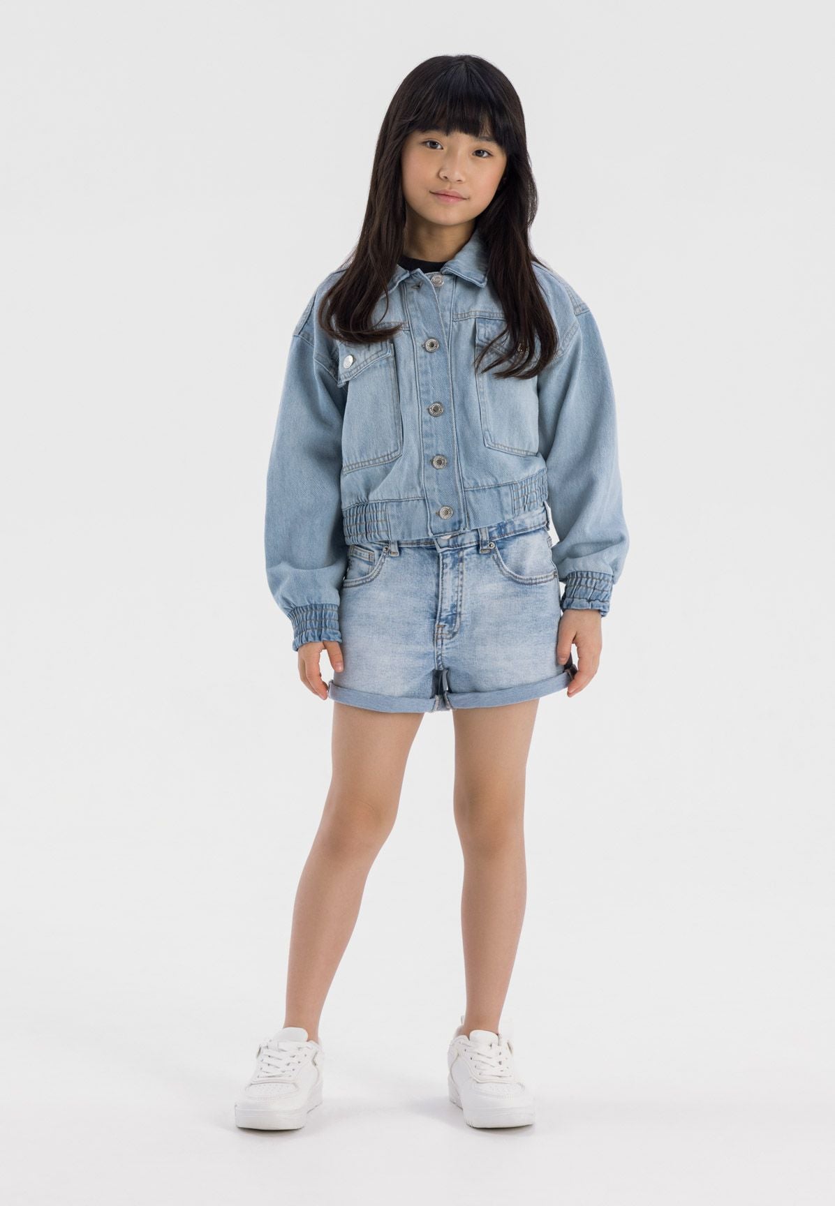 Girls high waist light blue denim shorts, front view with rolled cuffs and side pockets.