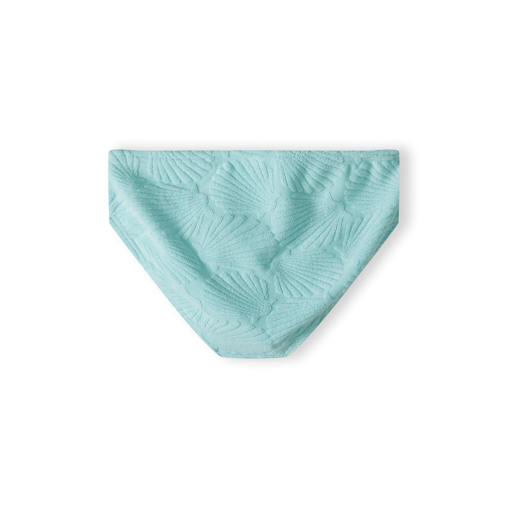 Close-up of mint green bikini bottom showing palm leaf texture pattern across the fabric surface against white background