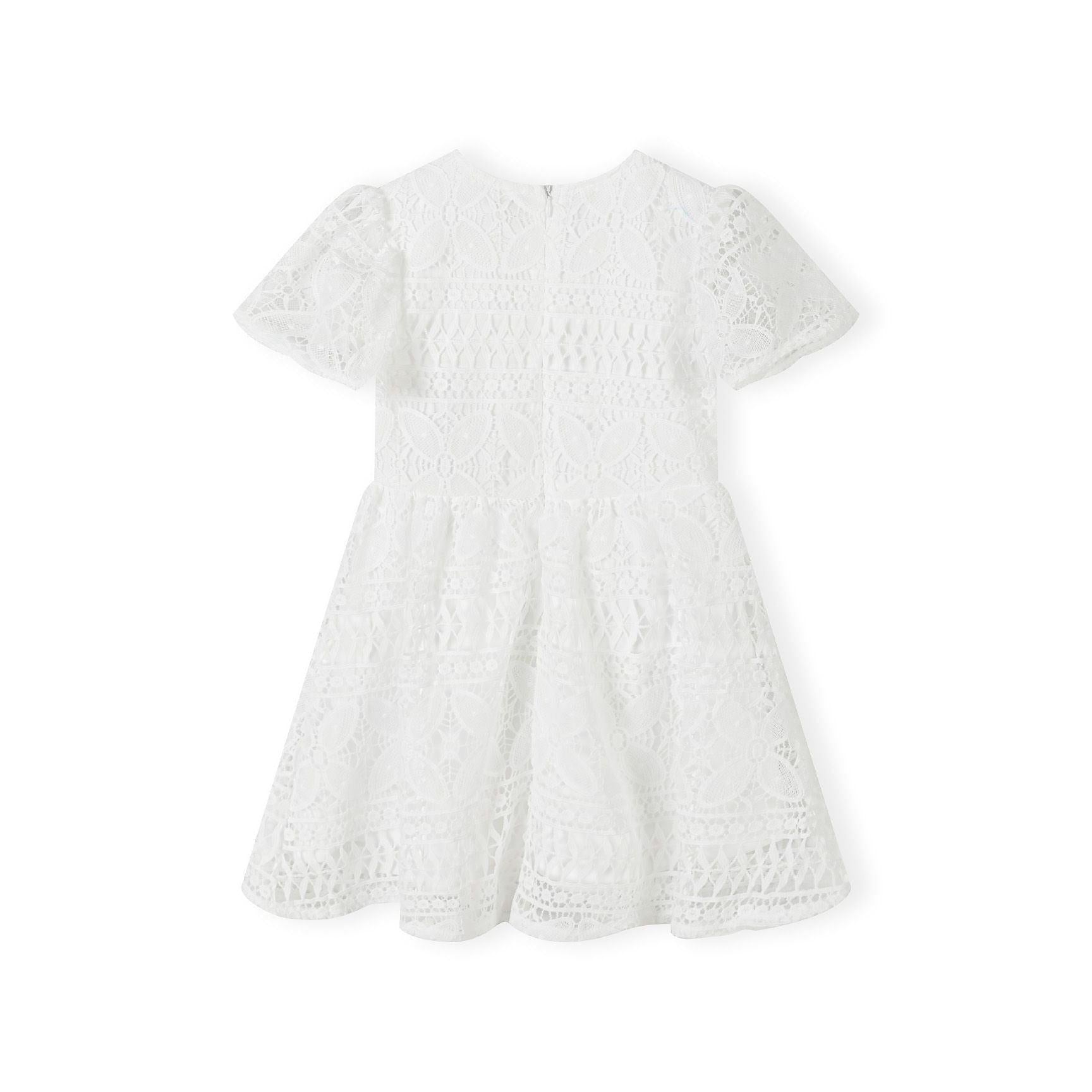 White lace dress laid flat showing intricate lace pattern, flared sleeves and circle skirt design on white background