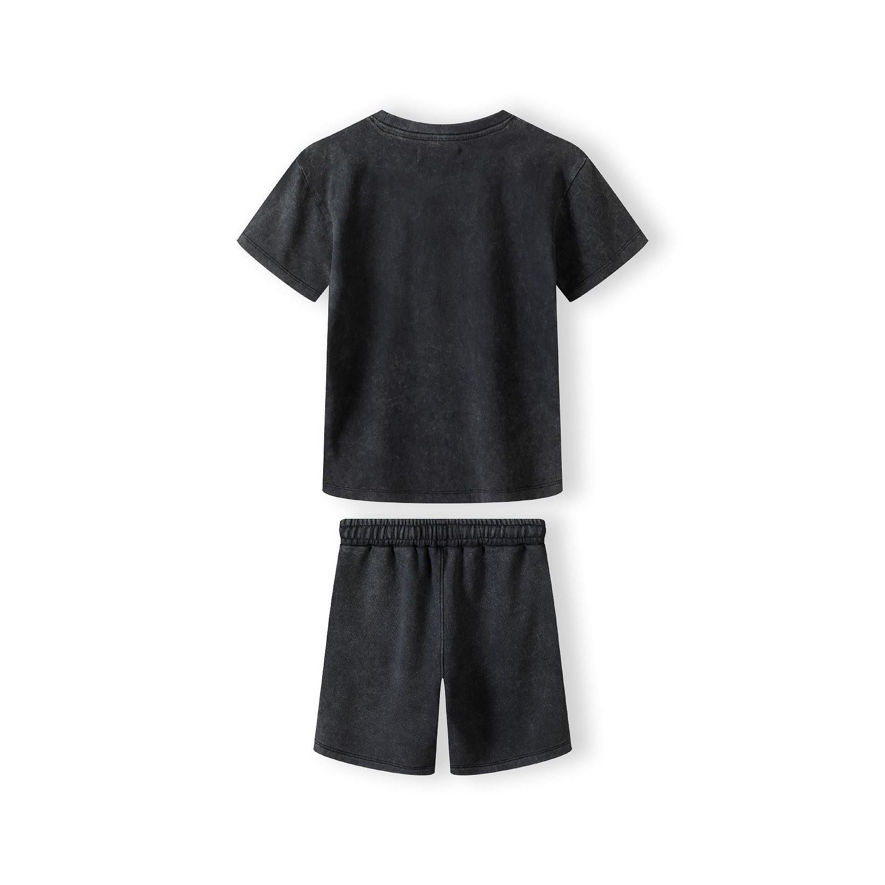 Close-up detail of washed grey fleece shorts showing elasticated waistband with white label and soft fabric texture