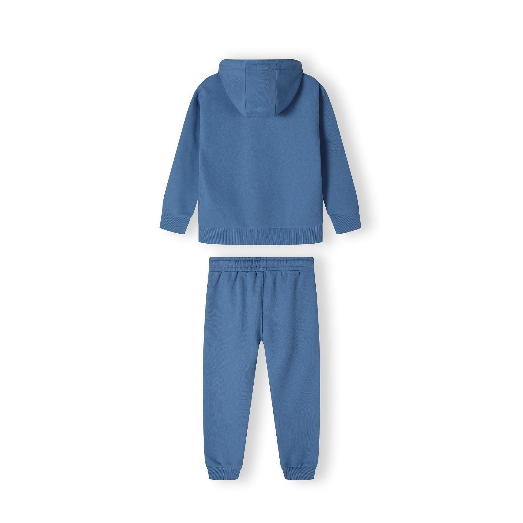 Close-up detail of blue joggers showing white 'Awesome Unlimited' text graphics on the leg