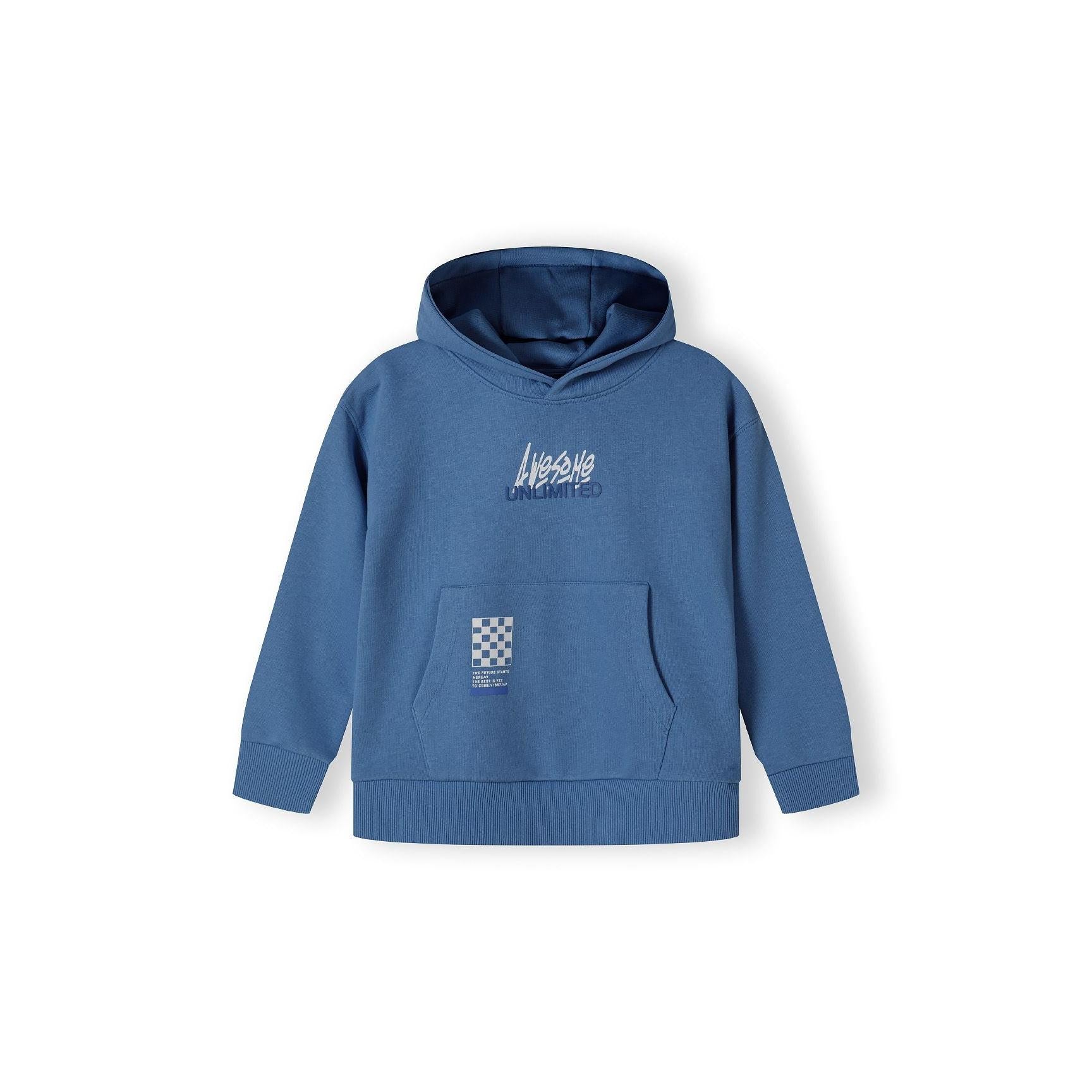 Close-up detail of blue joggers showing white 'Awesome Unlimited' text graphics on the leg